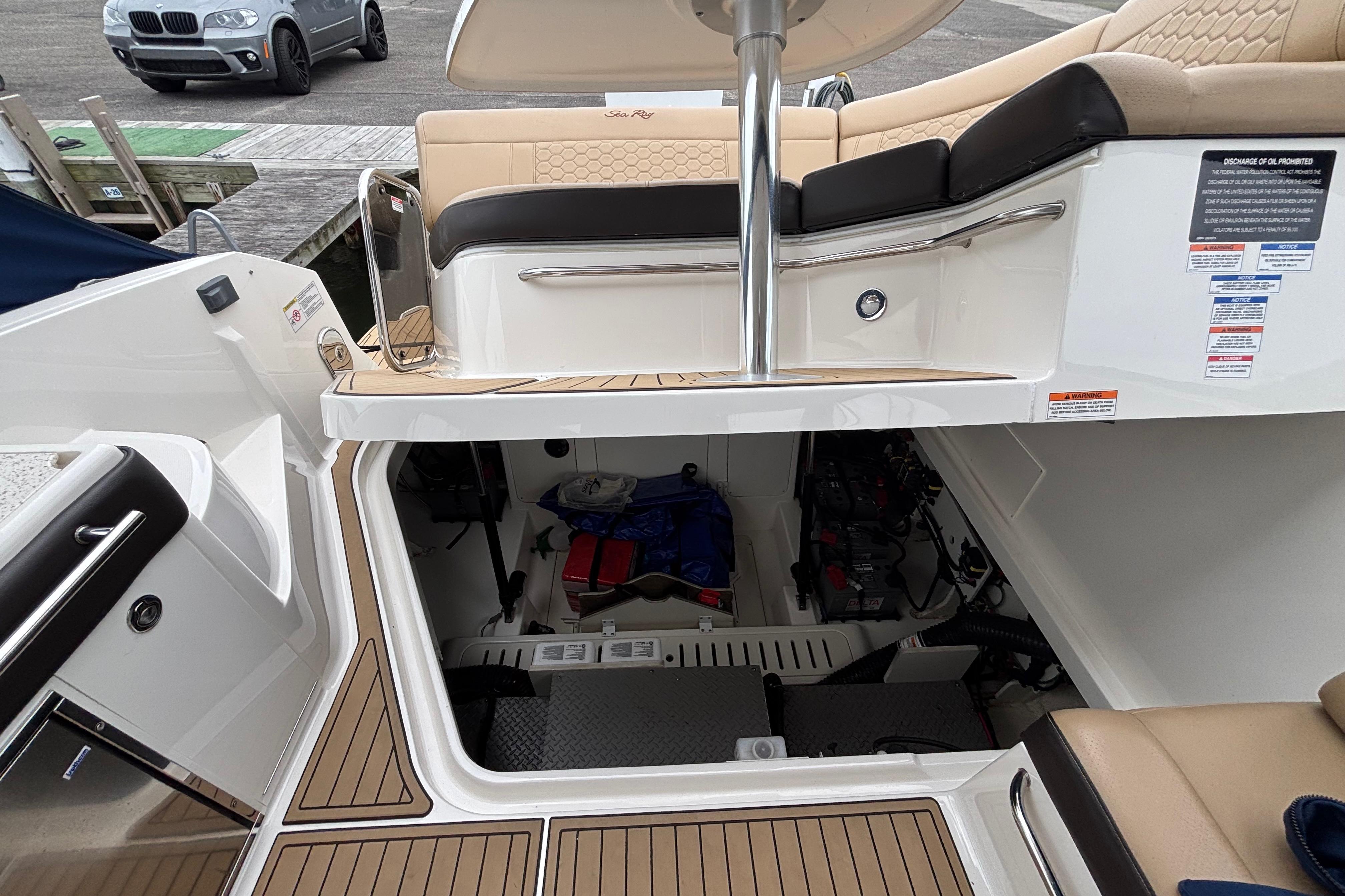 2021 Sea Ray Sundancer 320 Outboard interior with open storage compartment and seating area.