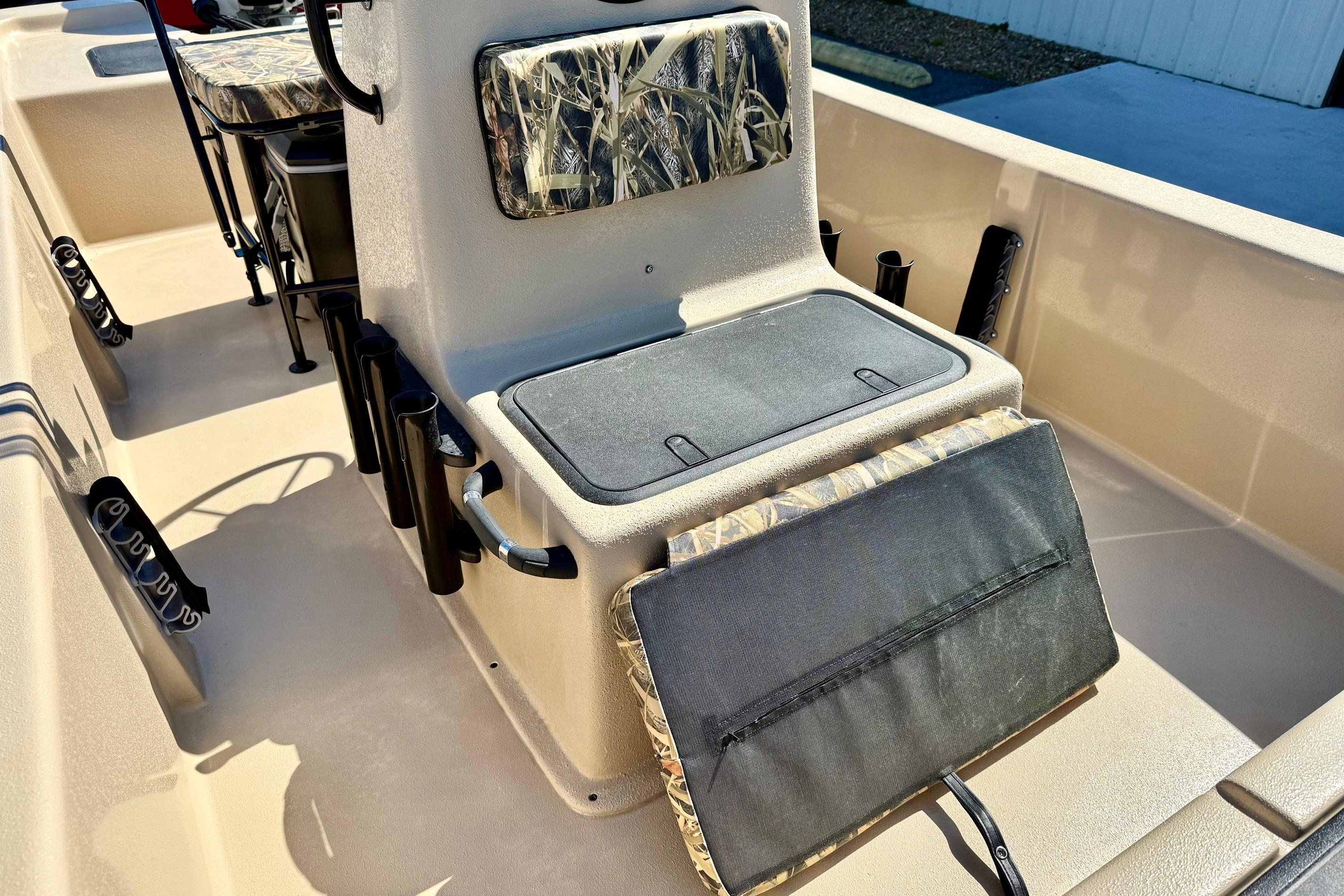 2026 Carolina Skiff E18 JVX CC boat interior with camo seating and storage compartments.