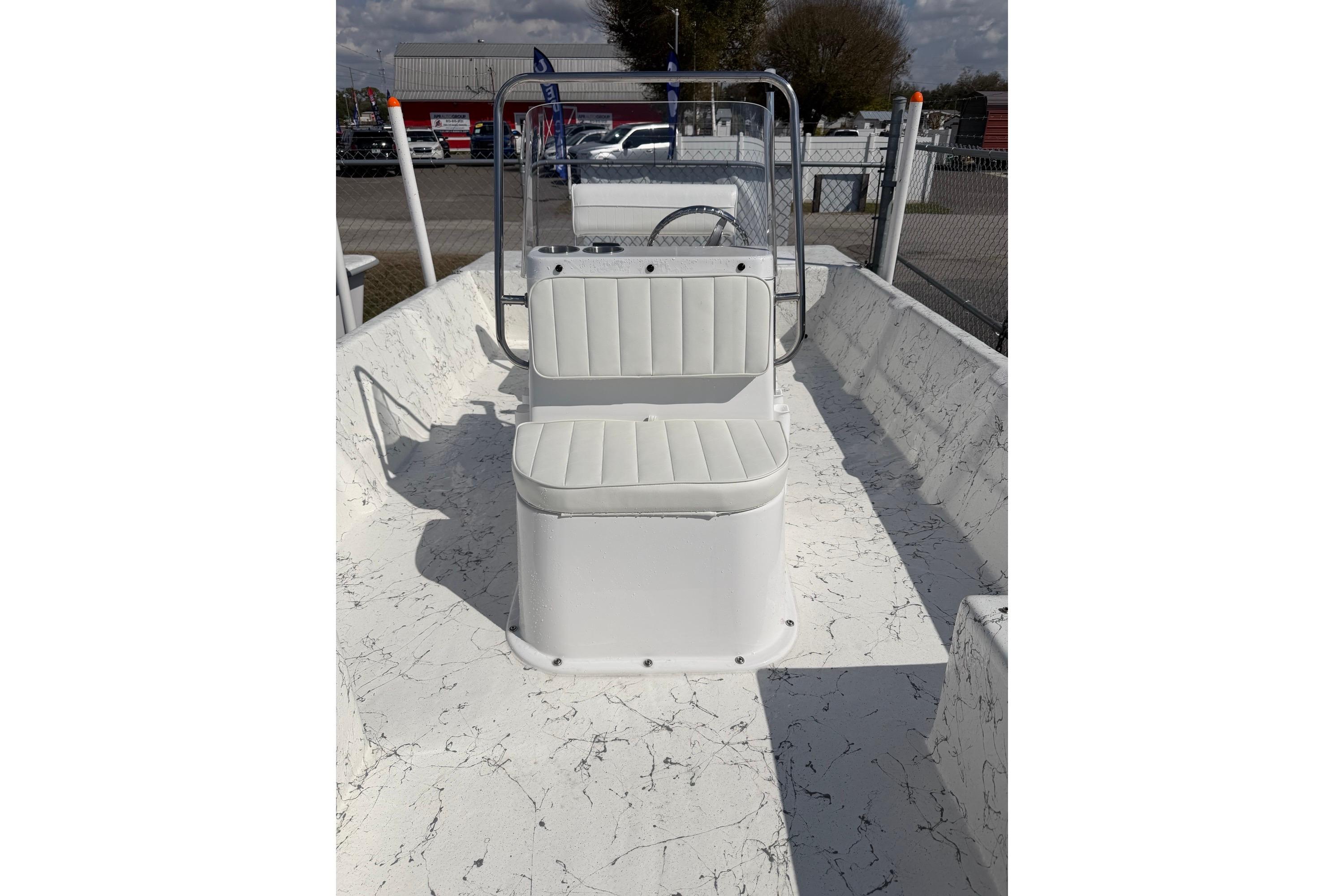 2027 Coastal Skiff 184 boat interior with white seating and marbled flooring.