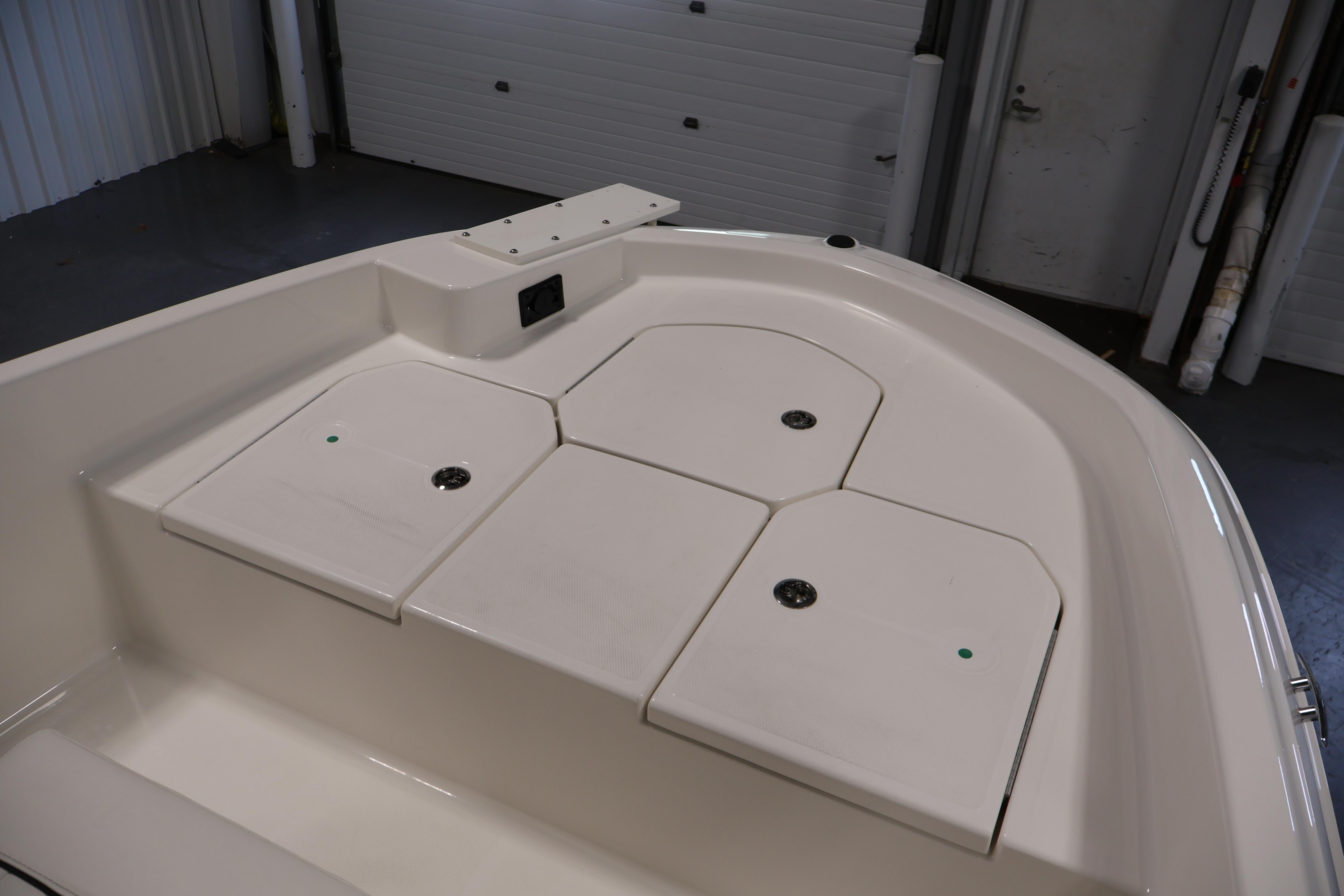 2026 Bayliner Trophy T18 boat interior with storage compartments in a showroom setting.