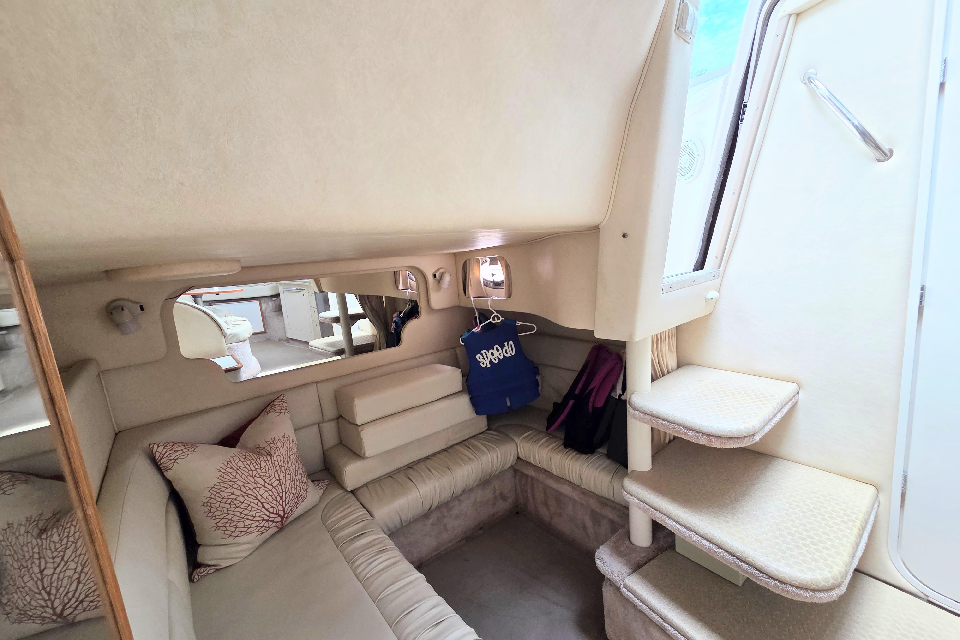 Interior of 2000 Sea Ray 340 Sundancer yacht with cozy seating and steps.