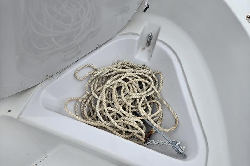 Rope and anchor in storage compartment of 1996 Boston Whaler Outrage 17 boat.