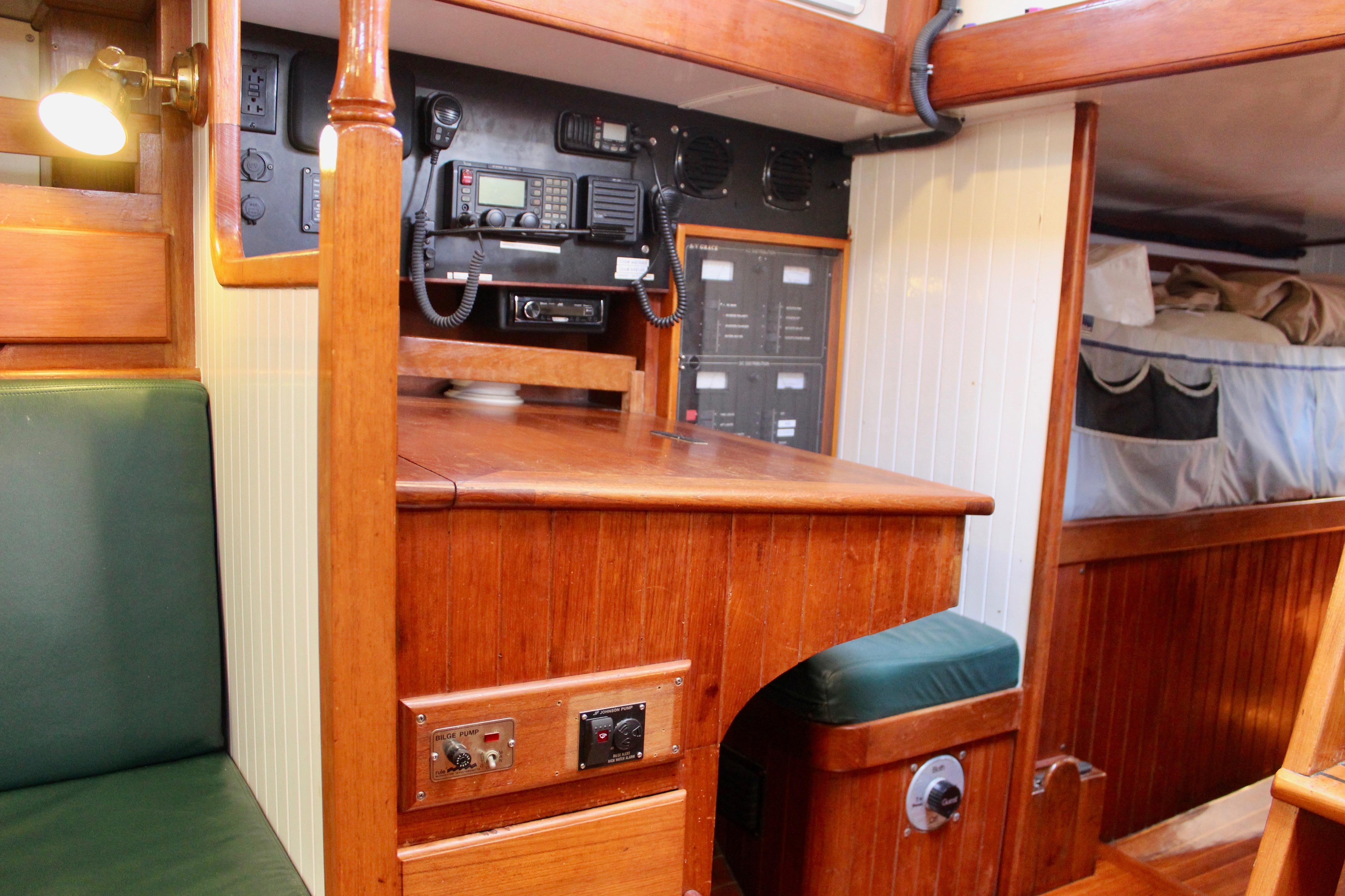 Interior of 1981 Kelly Peterson 46 yacht with navigation equipment and wooden furnishings.