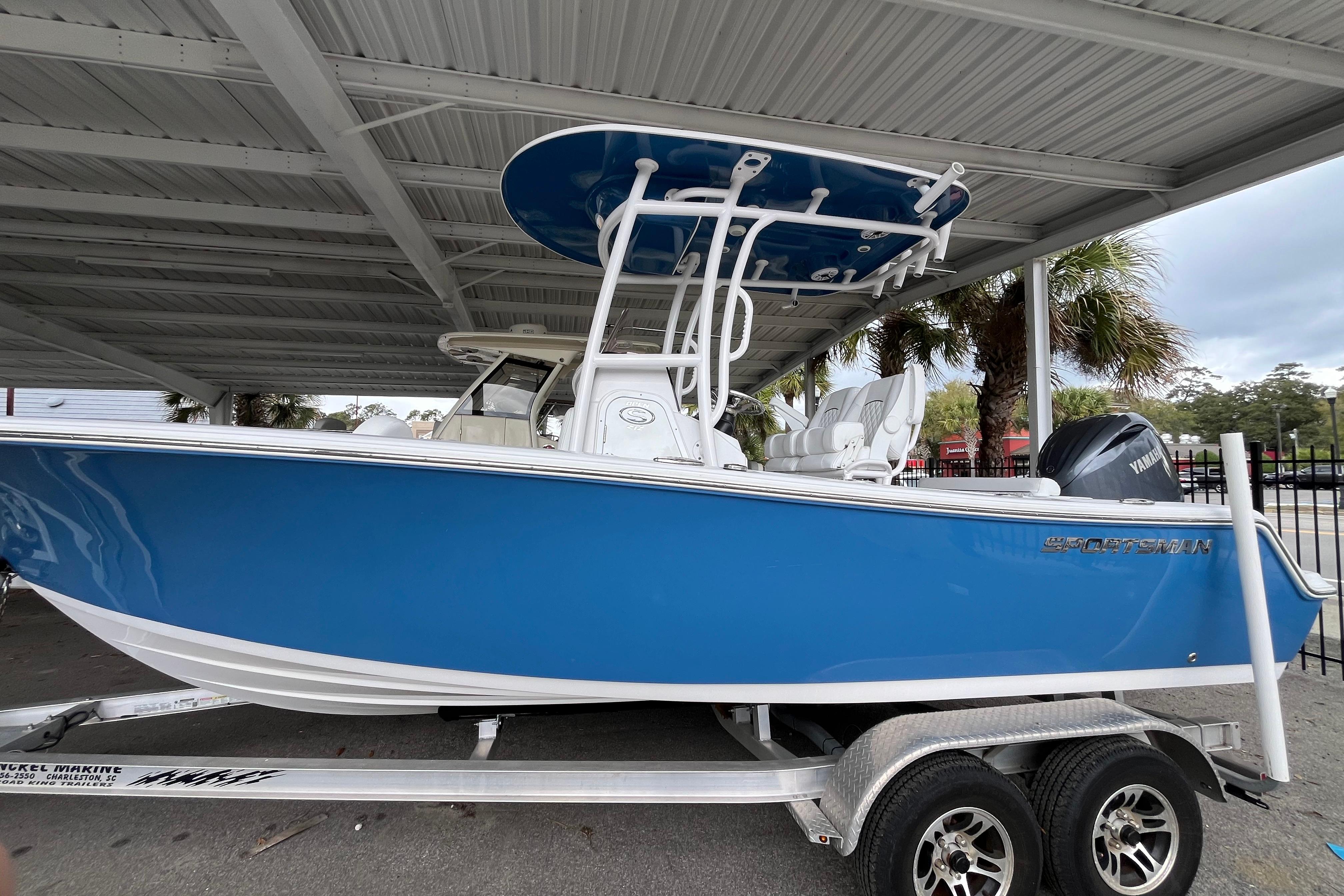 2024 Sportsman Open 212 Center Console boat in vibrant blue on a trailer.