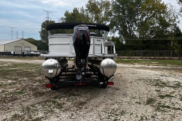 2026 Sun Tracker Party Barge 20 DLX pontoon boat on a gravel lot.
