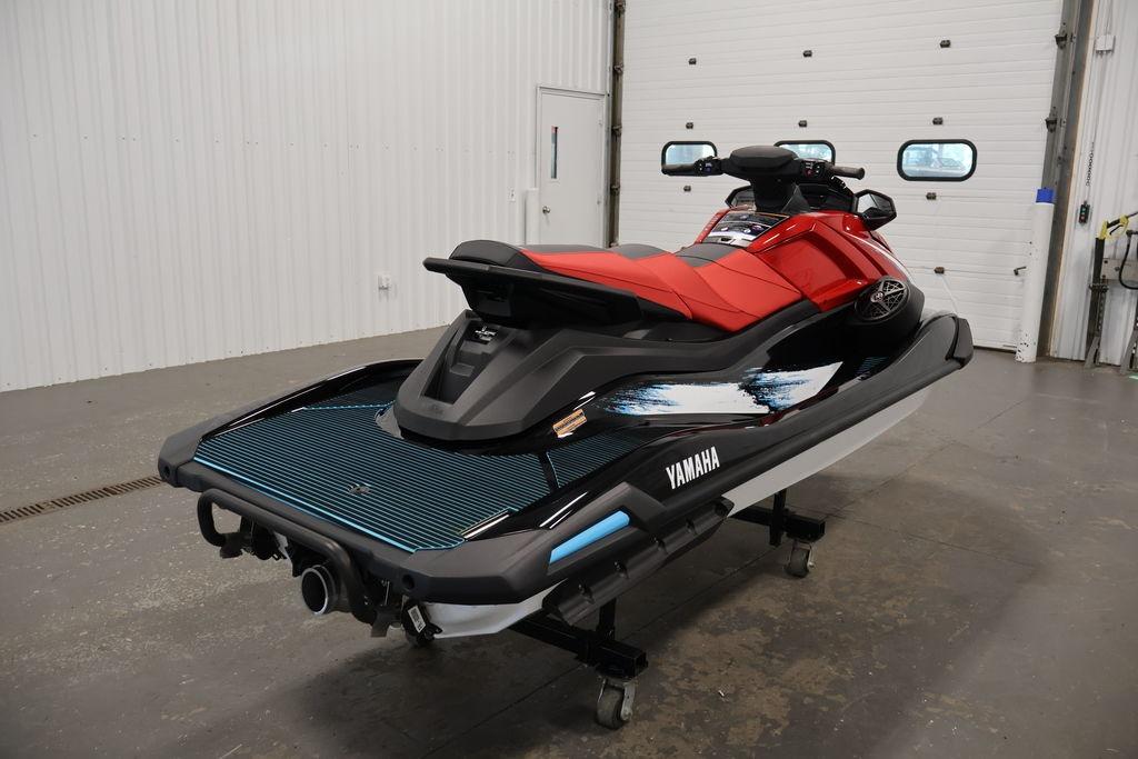 2026 Yamaha WaveRunner VX Deluxe in a showroom, showcasing sleek design and vibrant colors.