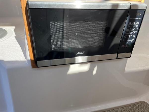 Microwave installed in 2025 Cutwater C-248 C (COUPE) boat interior.