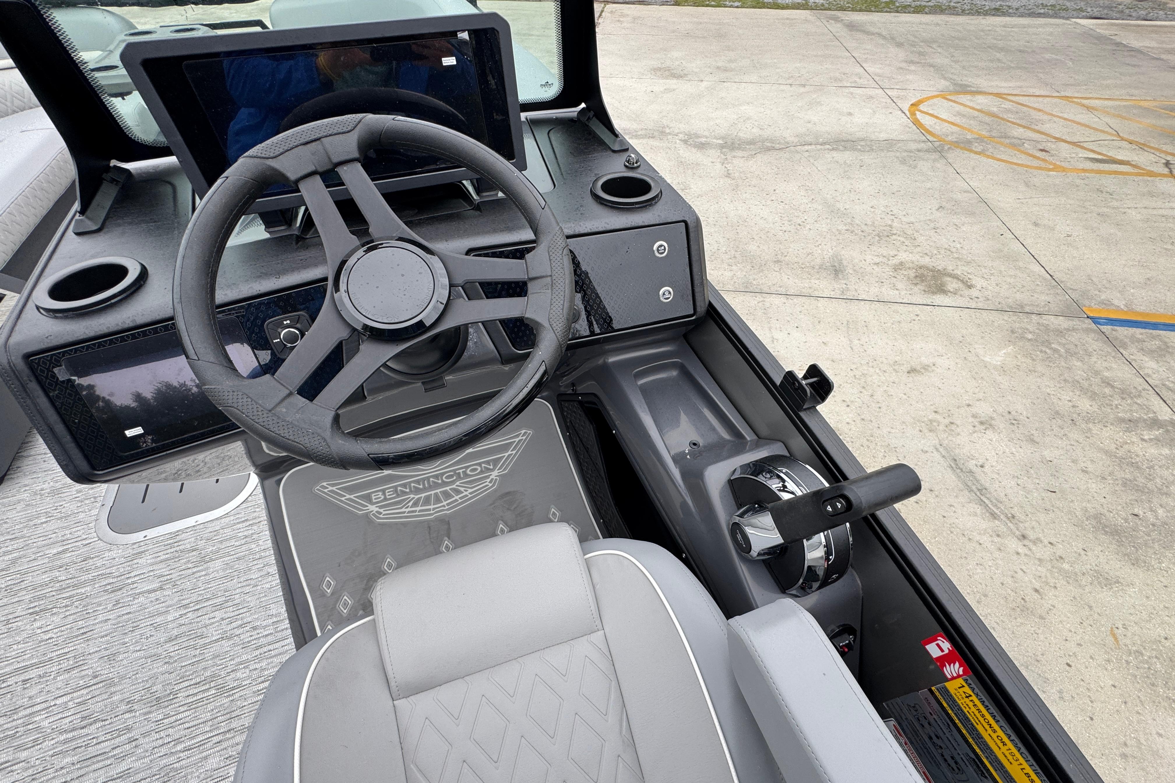 2027 Bennington 24 MFB boat dashboard with steering wheel and control panel.