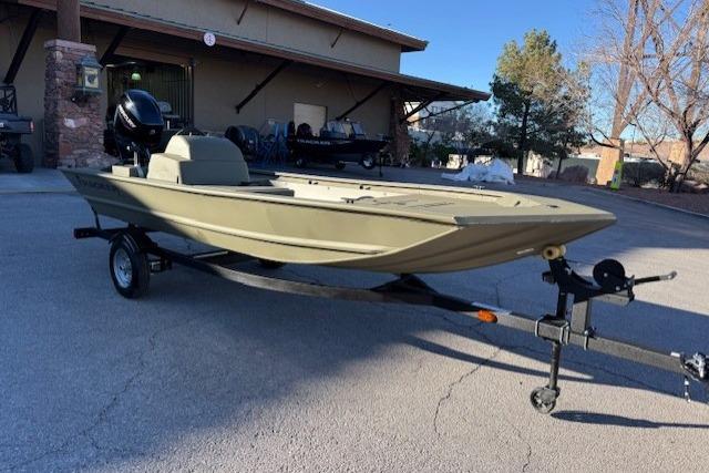 2026 Tracker Grizzly 1648 SC boat on trailer, parked outdoors.