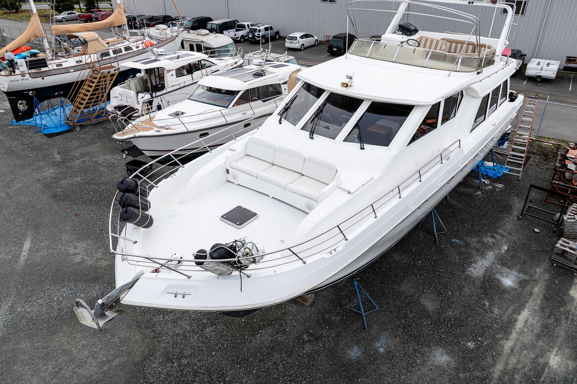 2001 Navigator Pilothouse yacht on dry dock, surrounded by other boats.