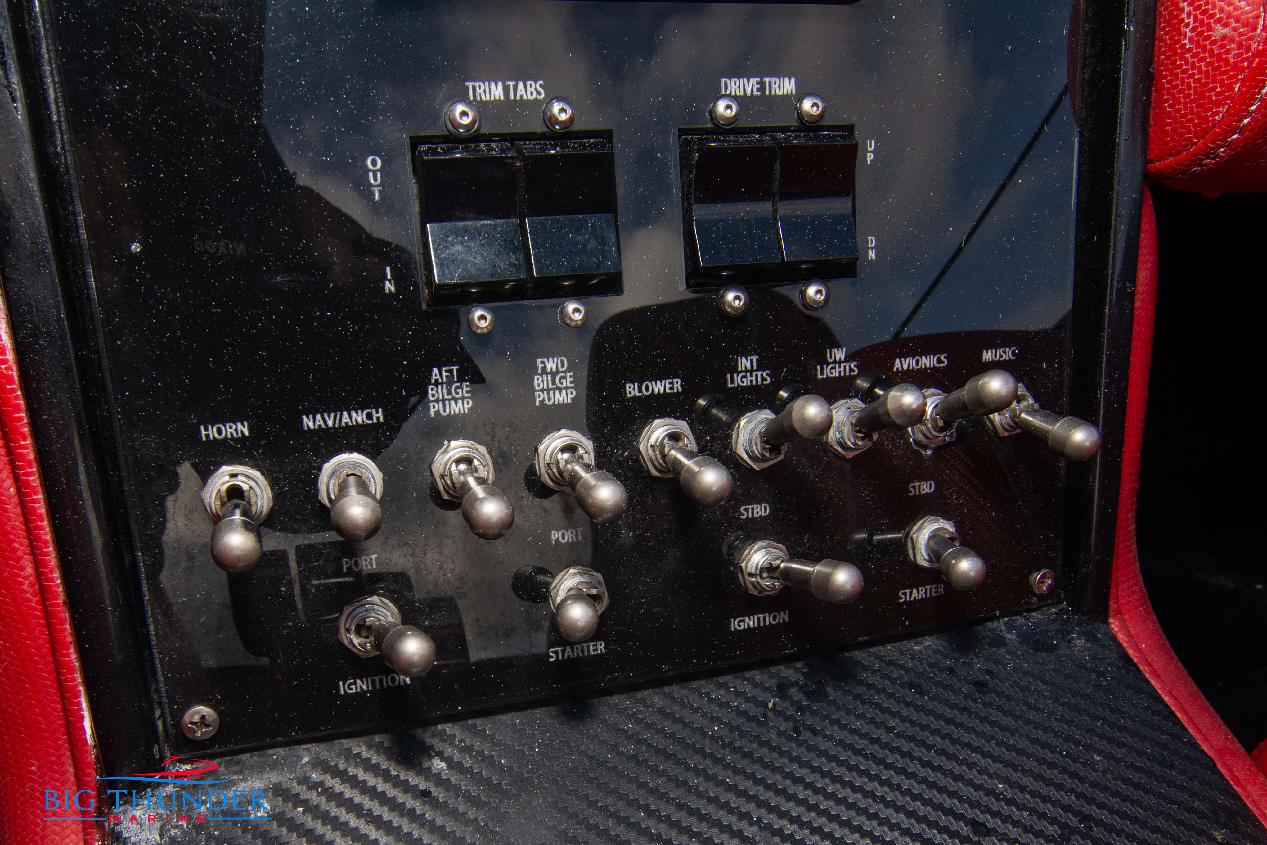 Control panel of a 2009 Donzi 38 ZRC boat with various switches and indicators.