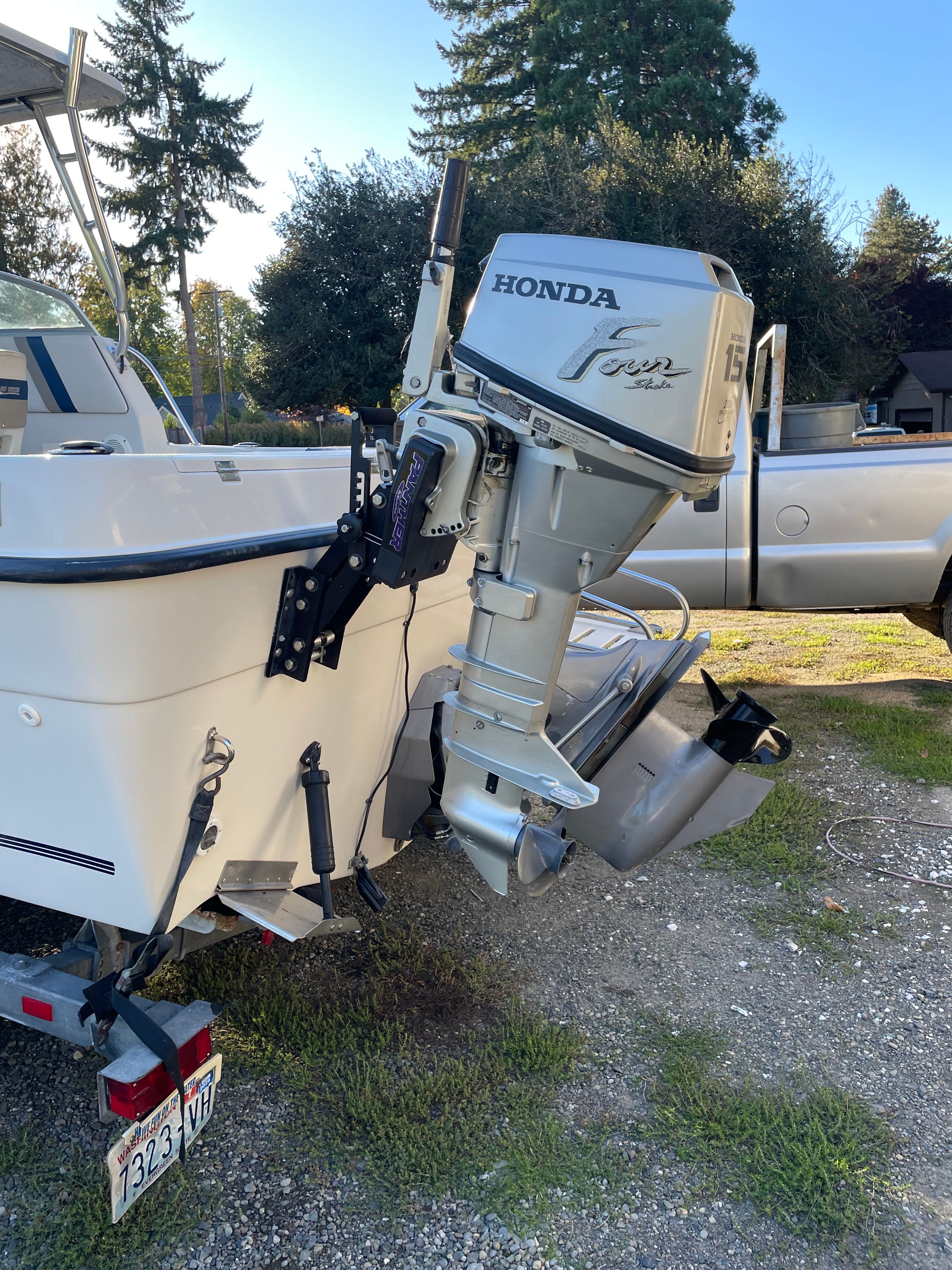 A Honda outboard motor is mounted on the stern of a 2001 Bluewater 2100 Sport Fisher.