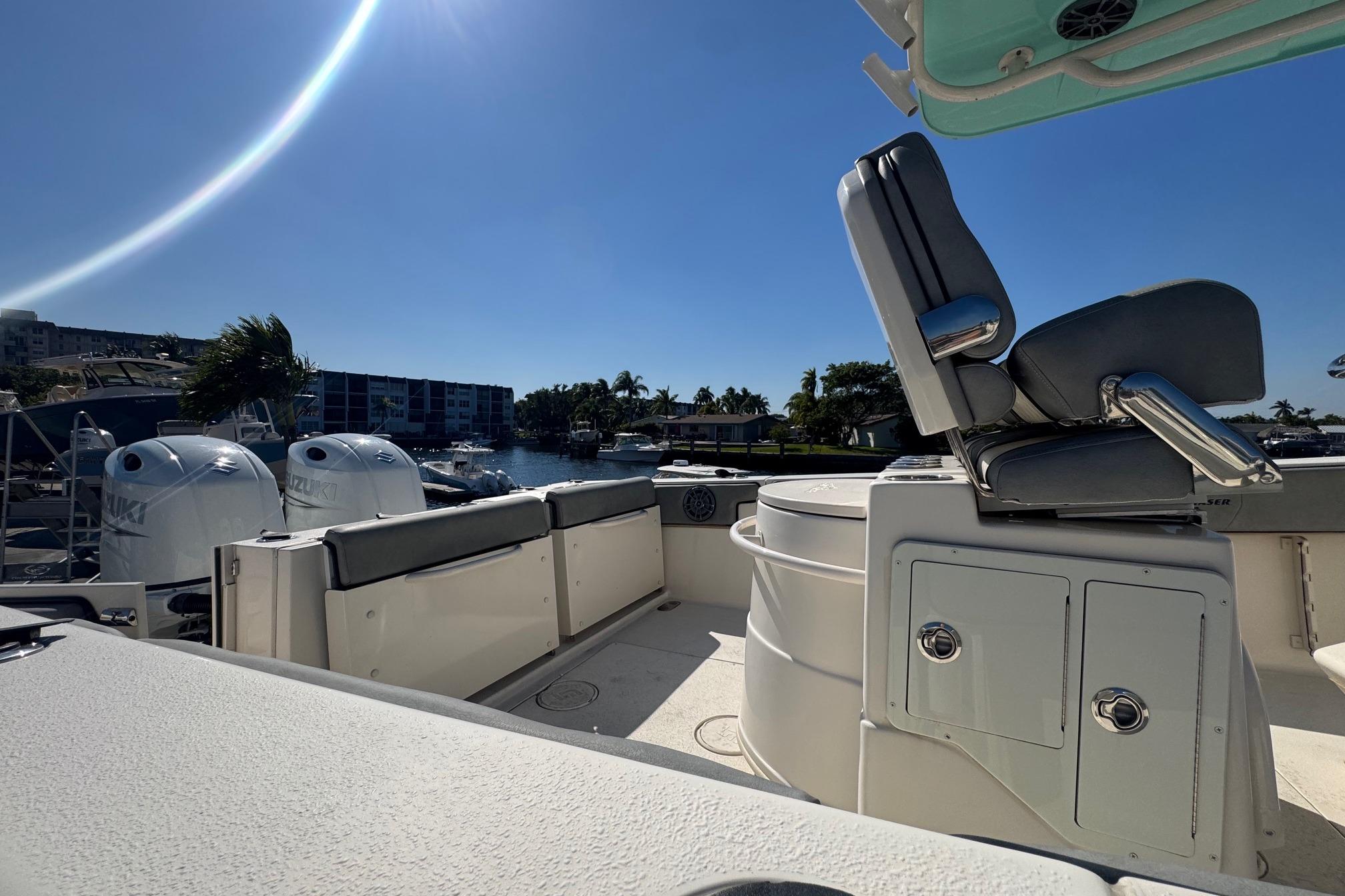 2023 Sea Chaser 27 HFC CC boat interior with seating and dual Suzuki engines.