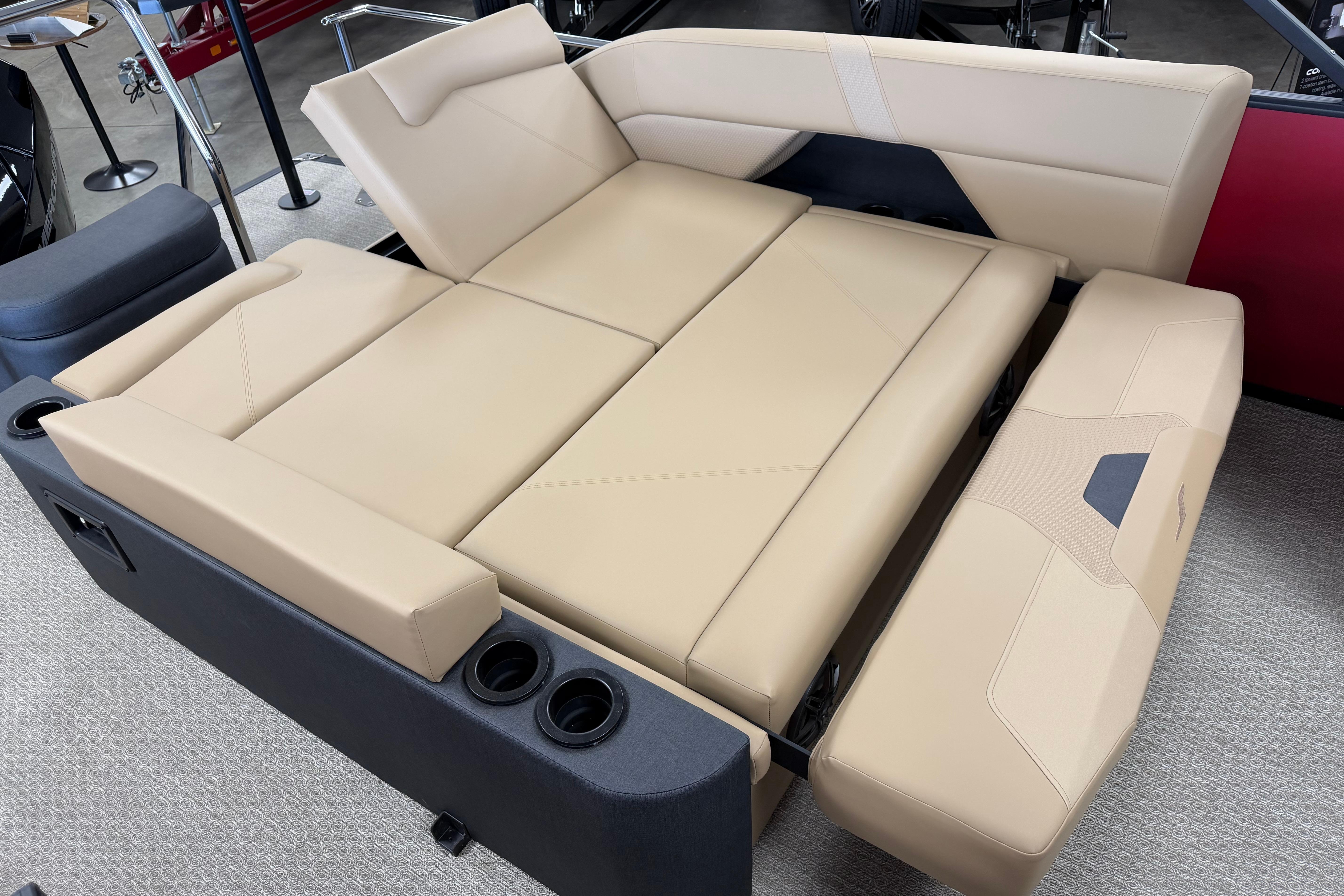 Luxurious beige seating in 2026 Evotti 523CS boat, featuring cup holders and modern design.