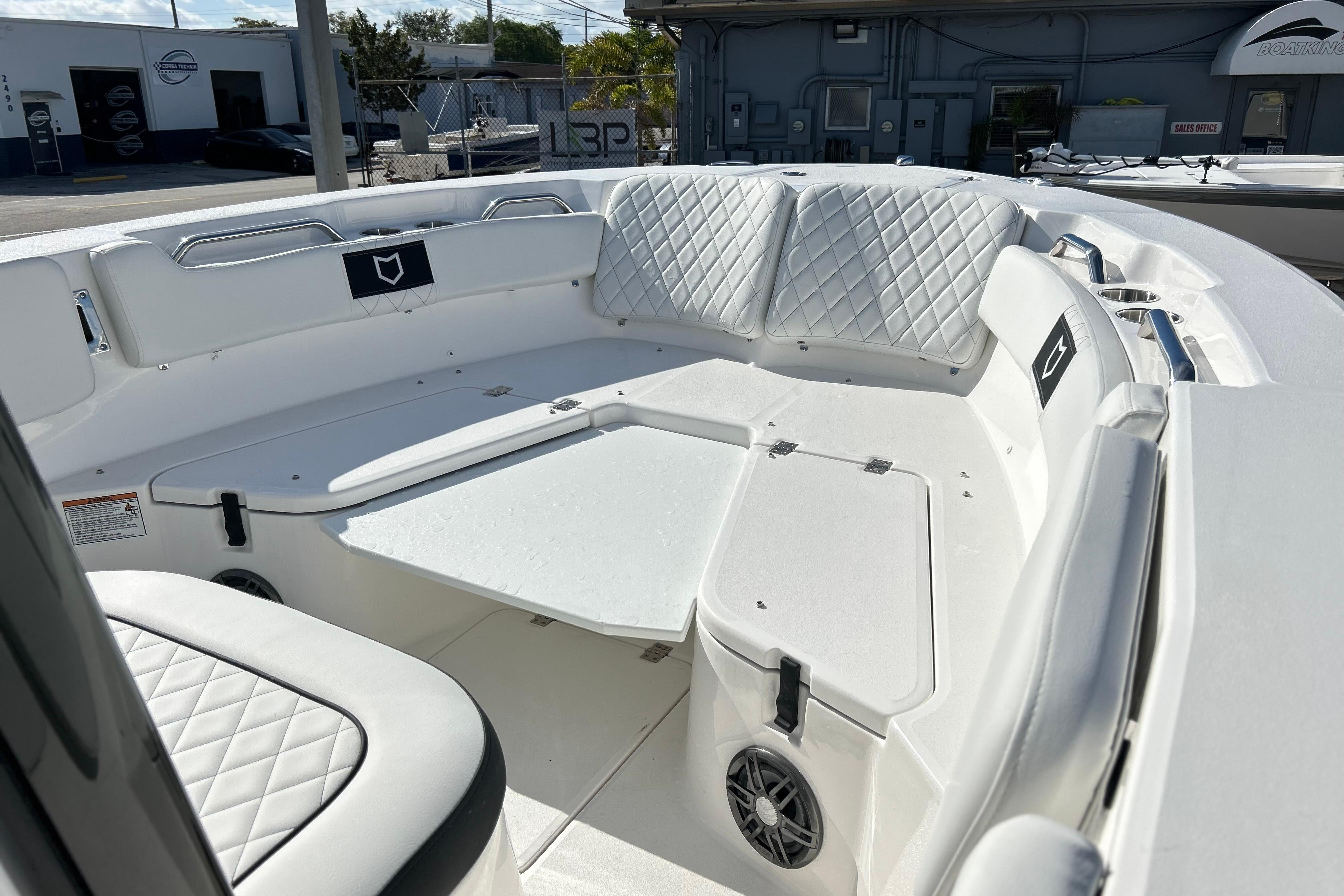 2026 Sea Fox 228 Commander boat interior with white cushioned seating and storage compartments.