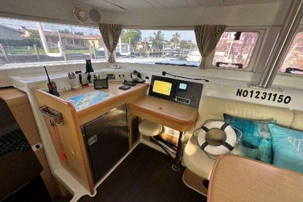 Interior of 2010 Lagoon 421 yacht with navigation station and seating area.