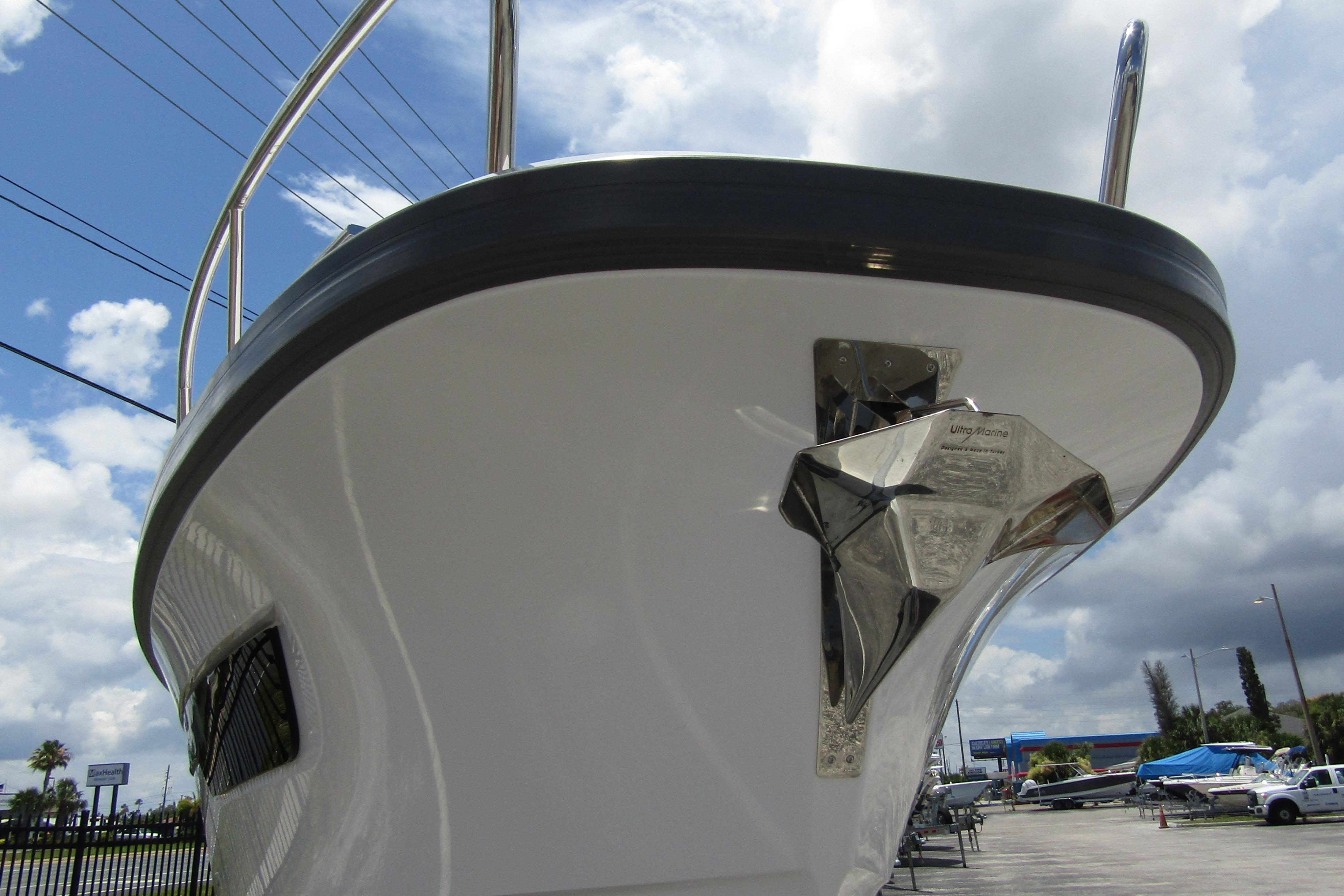 2025 Nimbus Tender 11 boat with stainless steel anchor, under a cloudy sky.