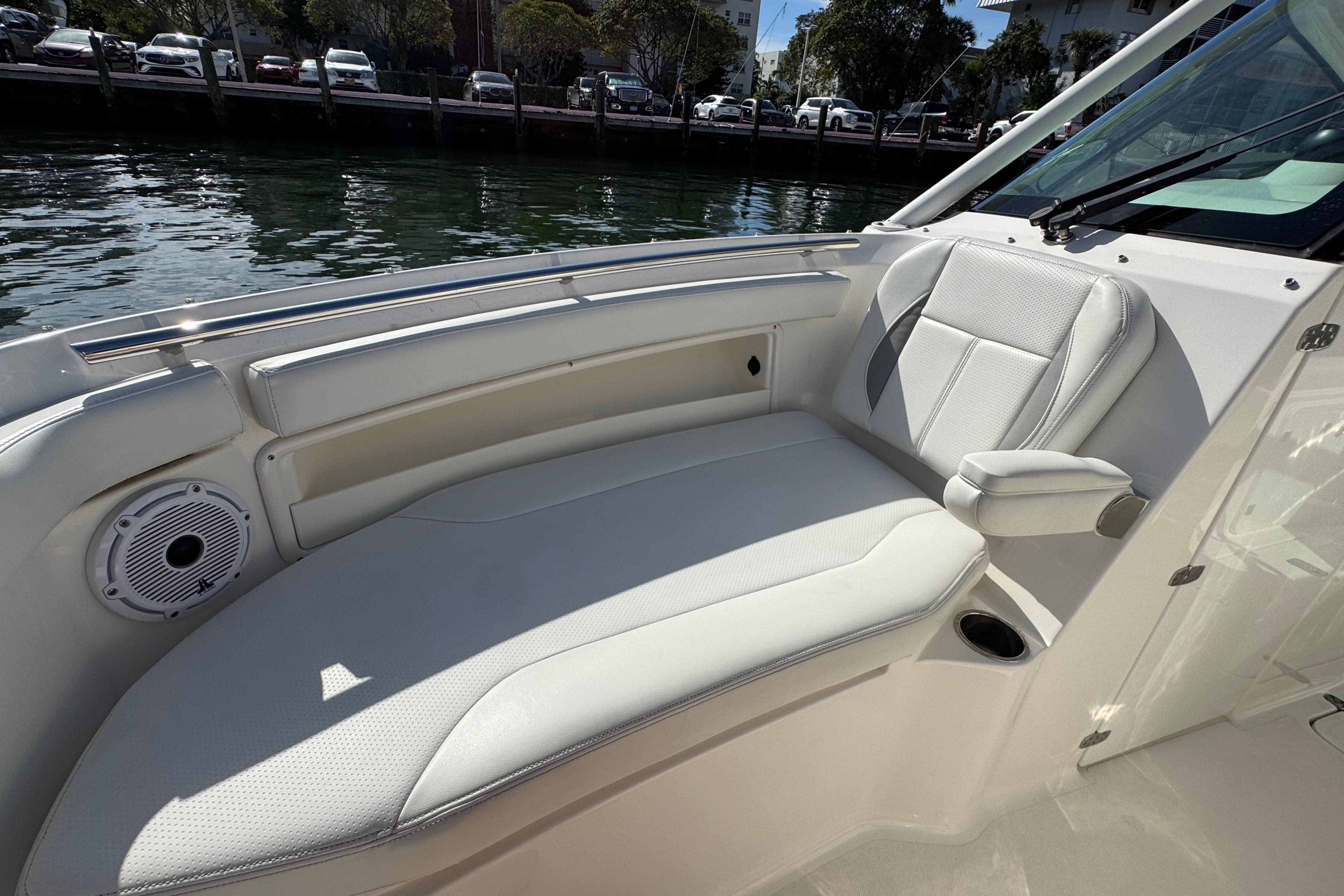 2022 Pursuit DC 266 Dual Console boat interior with white seating and waterfront view.