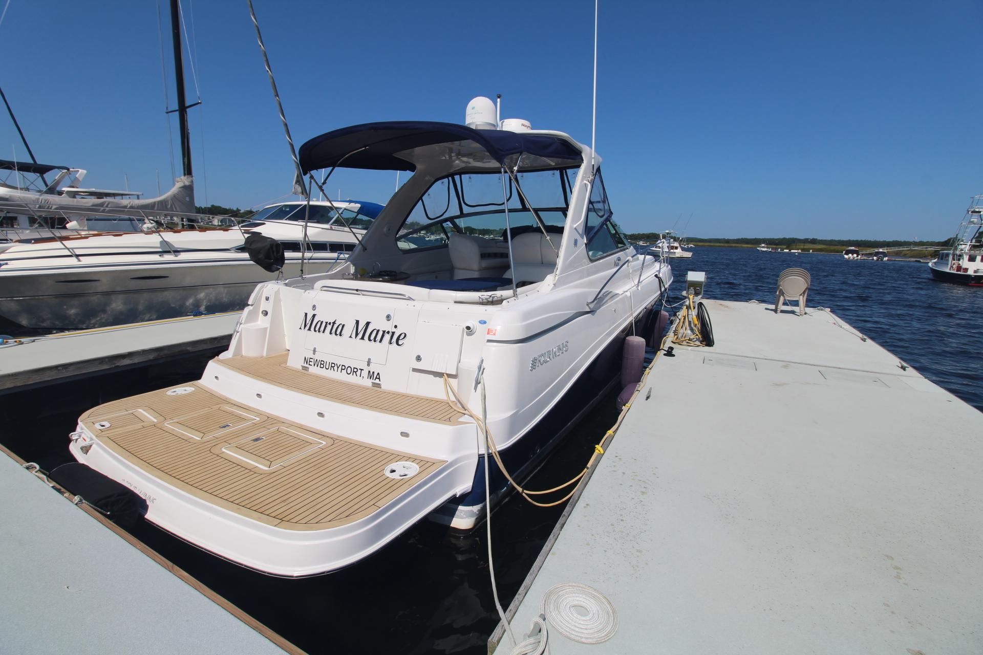 2006 Four Winns 378 Vista yacht docked at marina under clear blue sky.