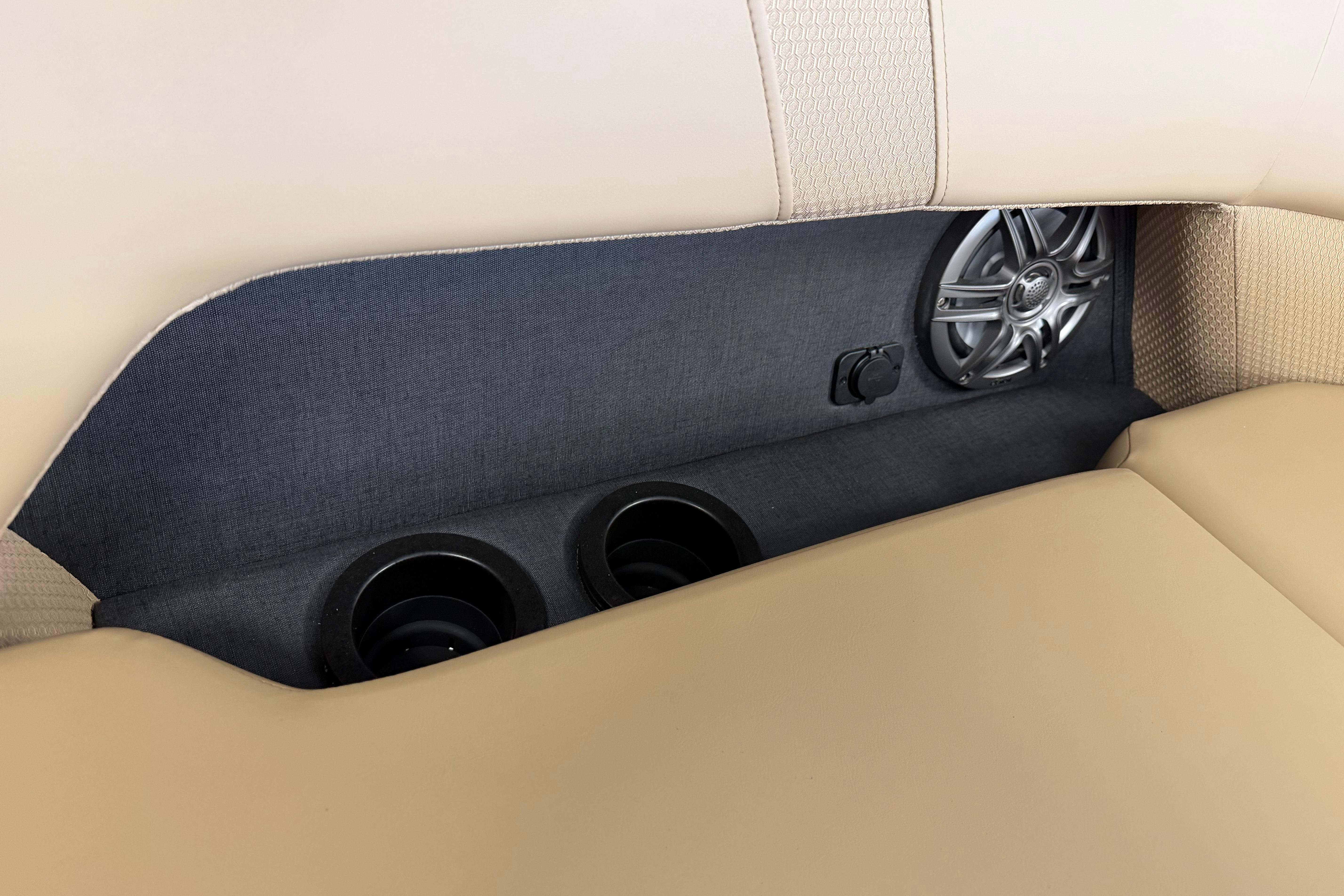 2026 Evotti 523CS interior with speaker and cup holders in beige upholstery.