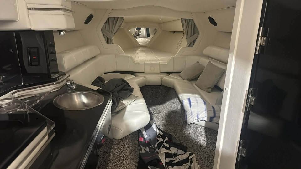 Interior of a 1996 Fountain 42Ft yacht with white leather and kitchenette.