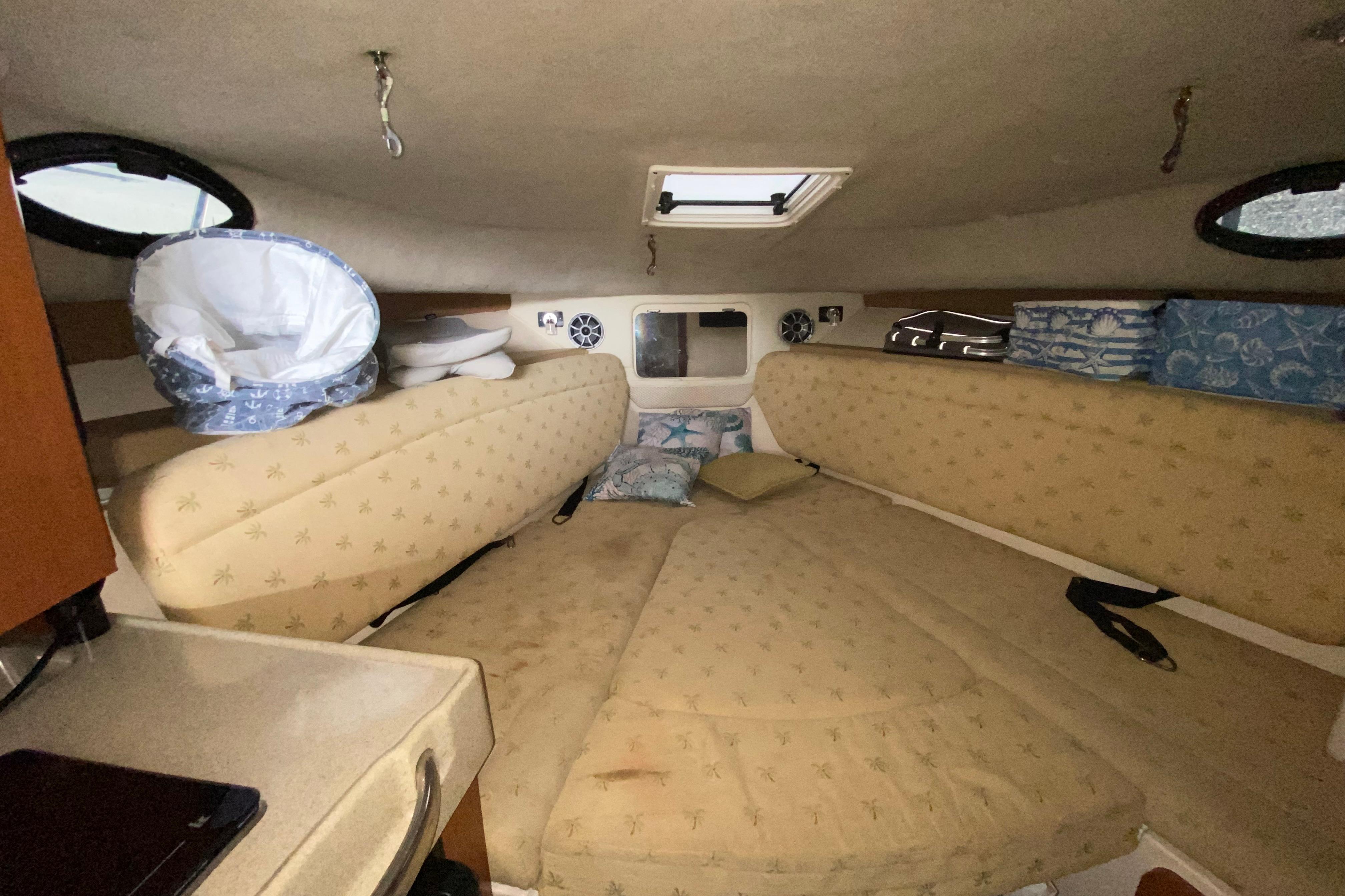 2005 Wellcraft 290 Coastal cabin interior with beige cushions and storage compartments.