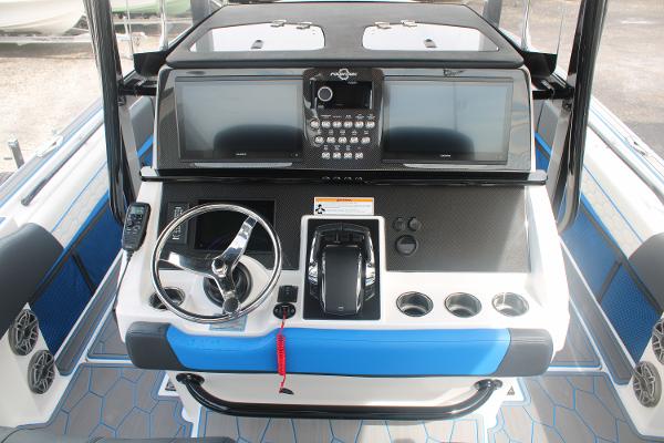 2024 Fountain 34 SC boat dashboard with steering wheel and control panel.