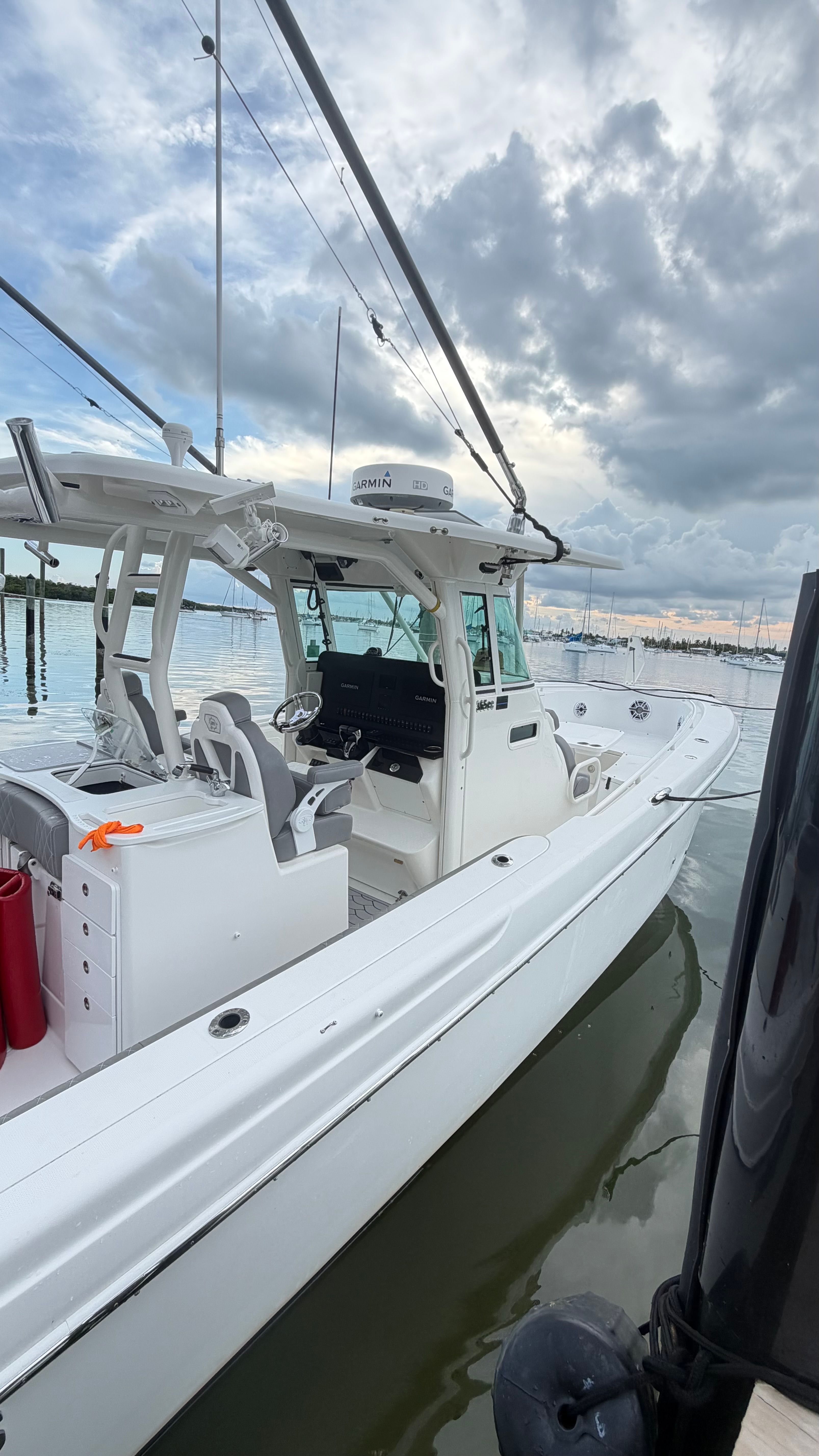 A 2009 Everglades 365 Center Console boat is on the water, surrounded by other boats.