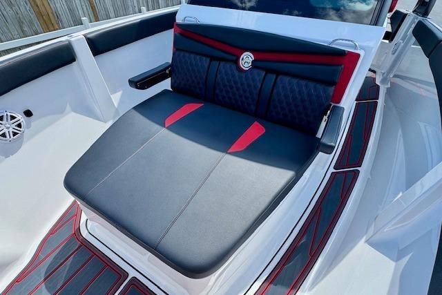 2026 Monterey Elite 25 OB boat interior with stylish black and red seating.