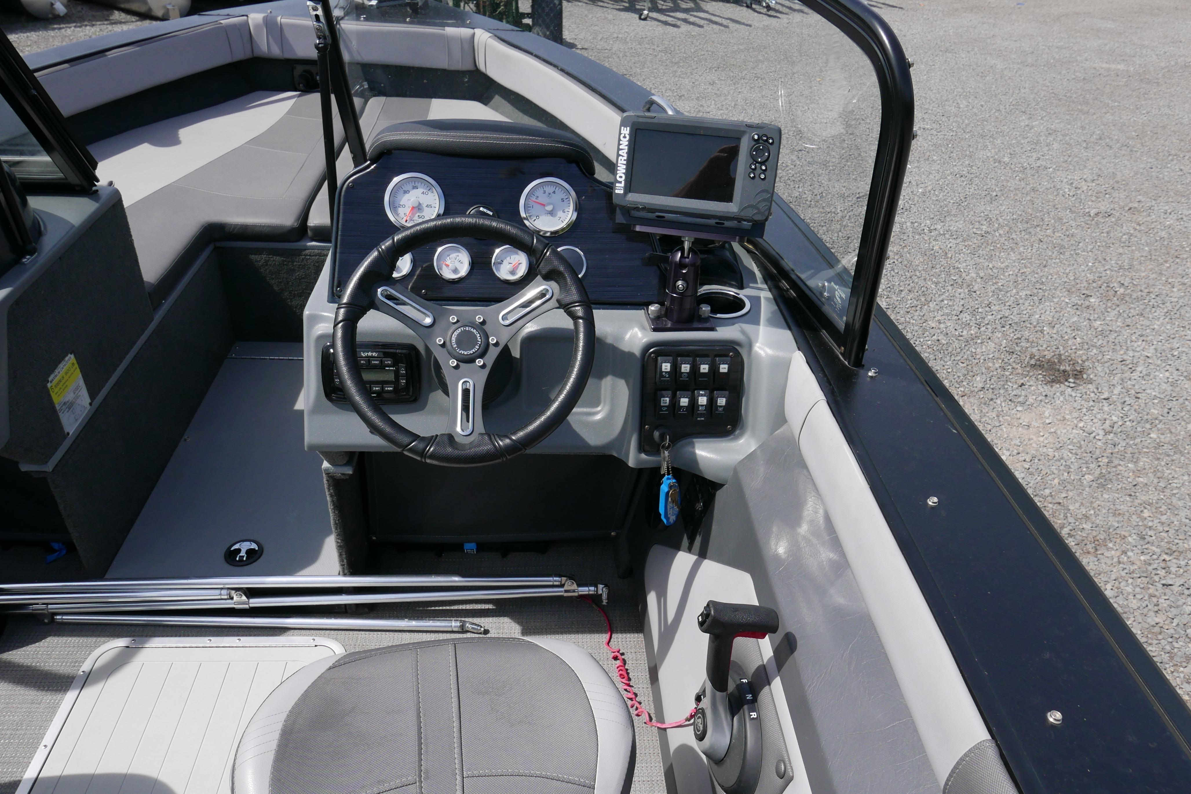 2016 Starcraft Titan 186 boat dashboard with steering wheel and navigation system.