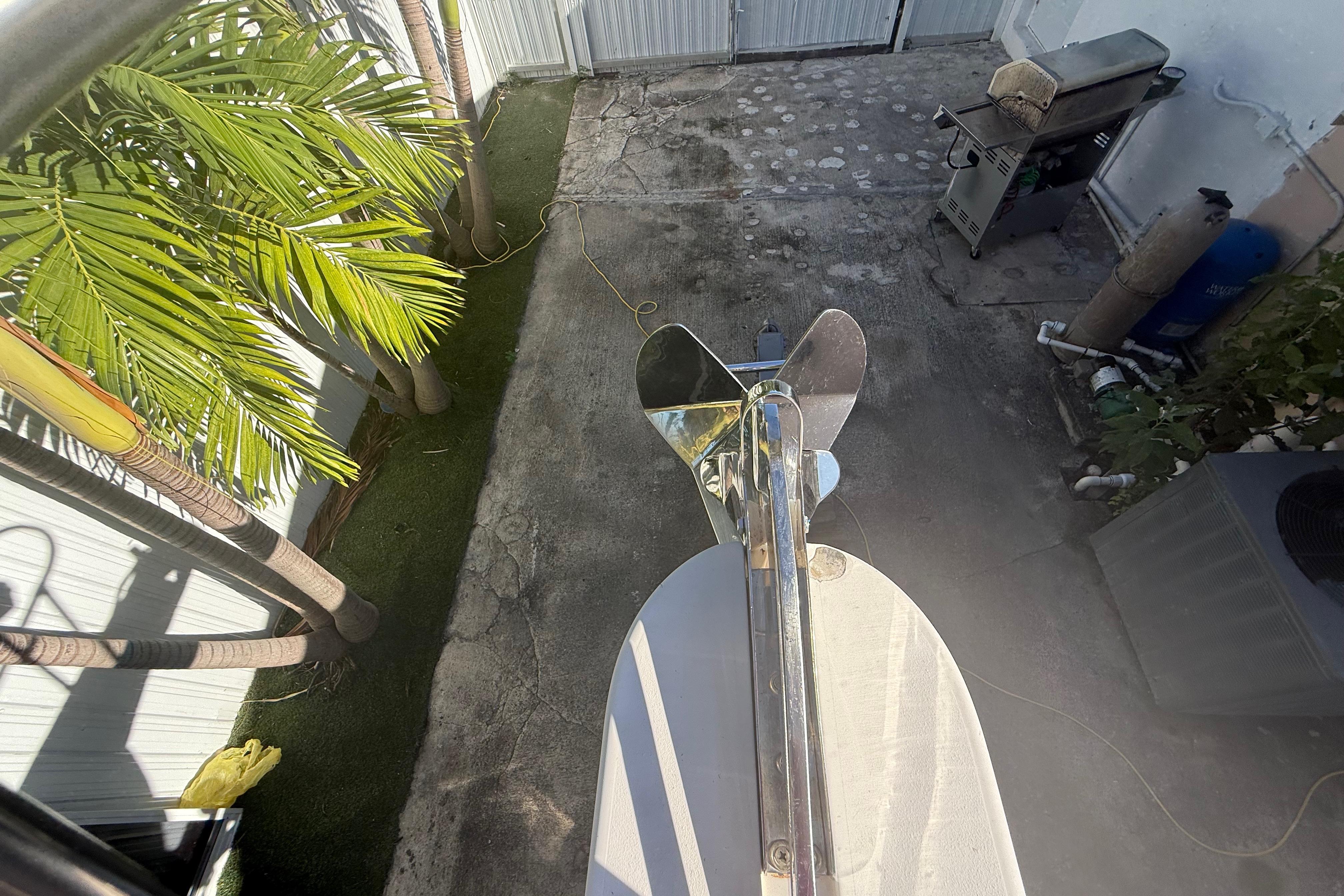 Overhead view of Grady-White Sailfish 272 anchor, 1996 model, near palm trees and patio.