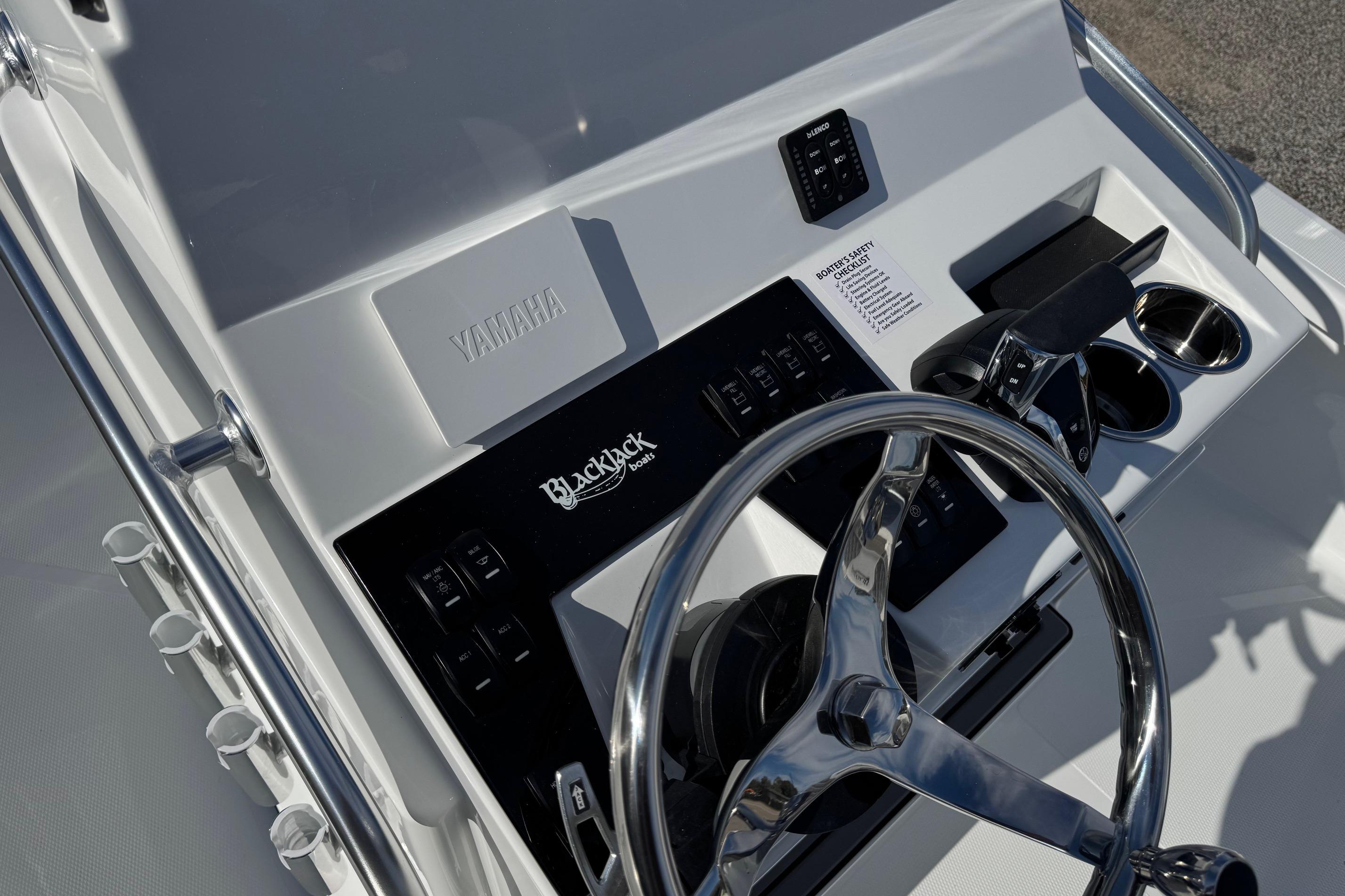 2026 BlackJack 256 Bay boat console with steering wheel and controls.