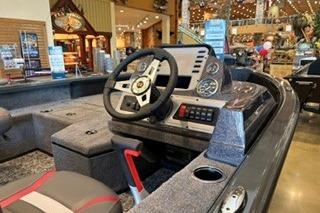 2026 Ranger VS1682SC Angler boat interior with steering wheel and dashboard in showroom.