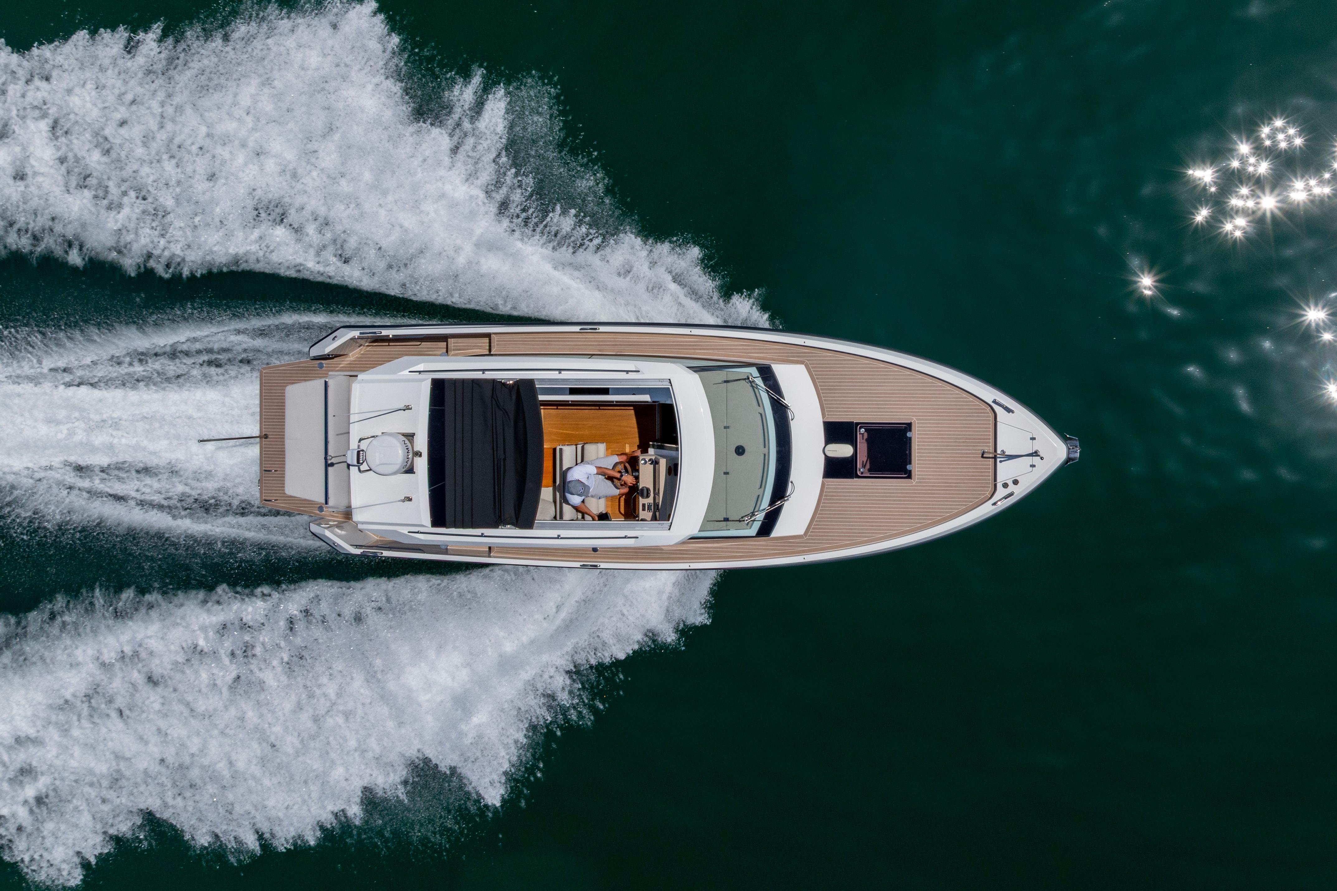 Aerial view of 2023 Delta Powerboats 33 Coupe cruising on water.