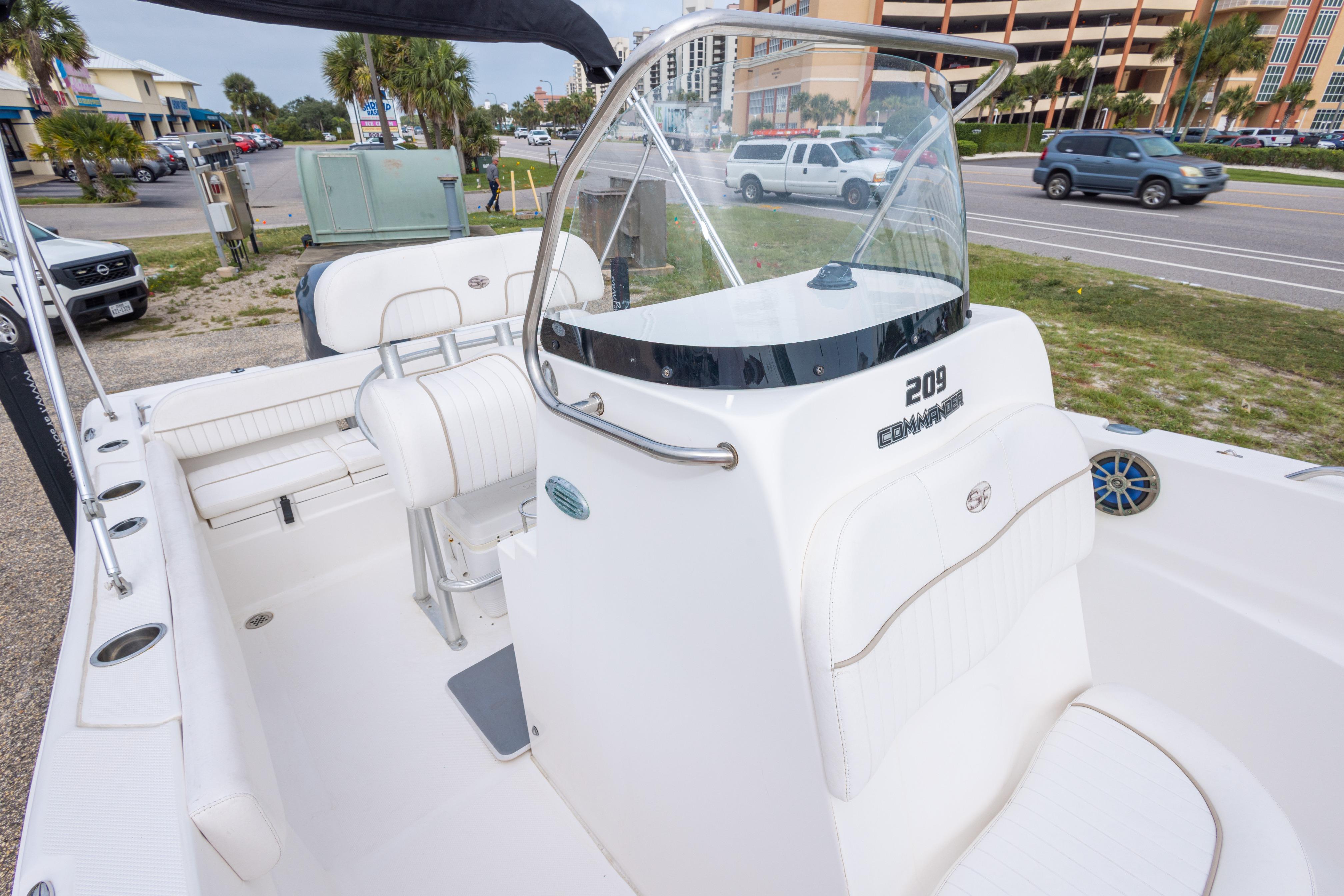 2014 Sea Fox 209 Commander boat interior with seating and console, parked near a road.