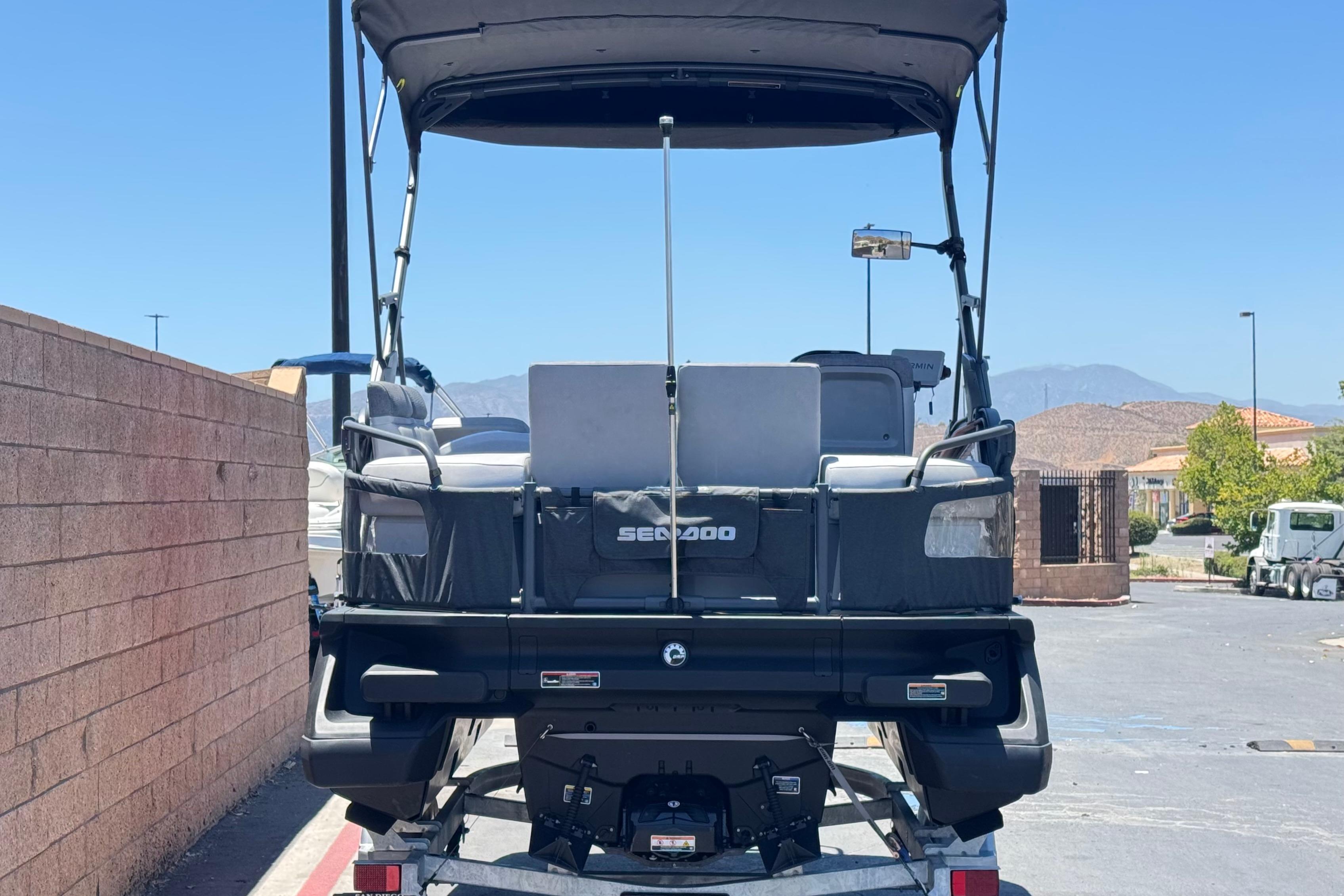 2024 Sea-Doo Switch Compact pontoon boat parked outdoors, rear view.