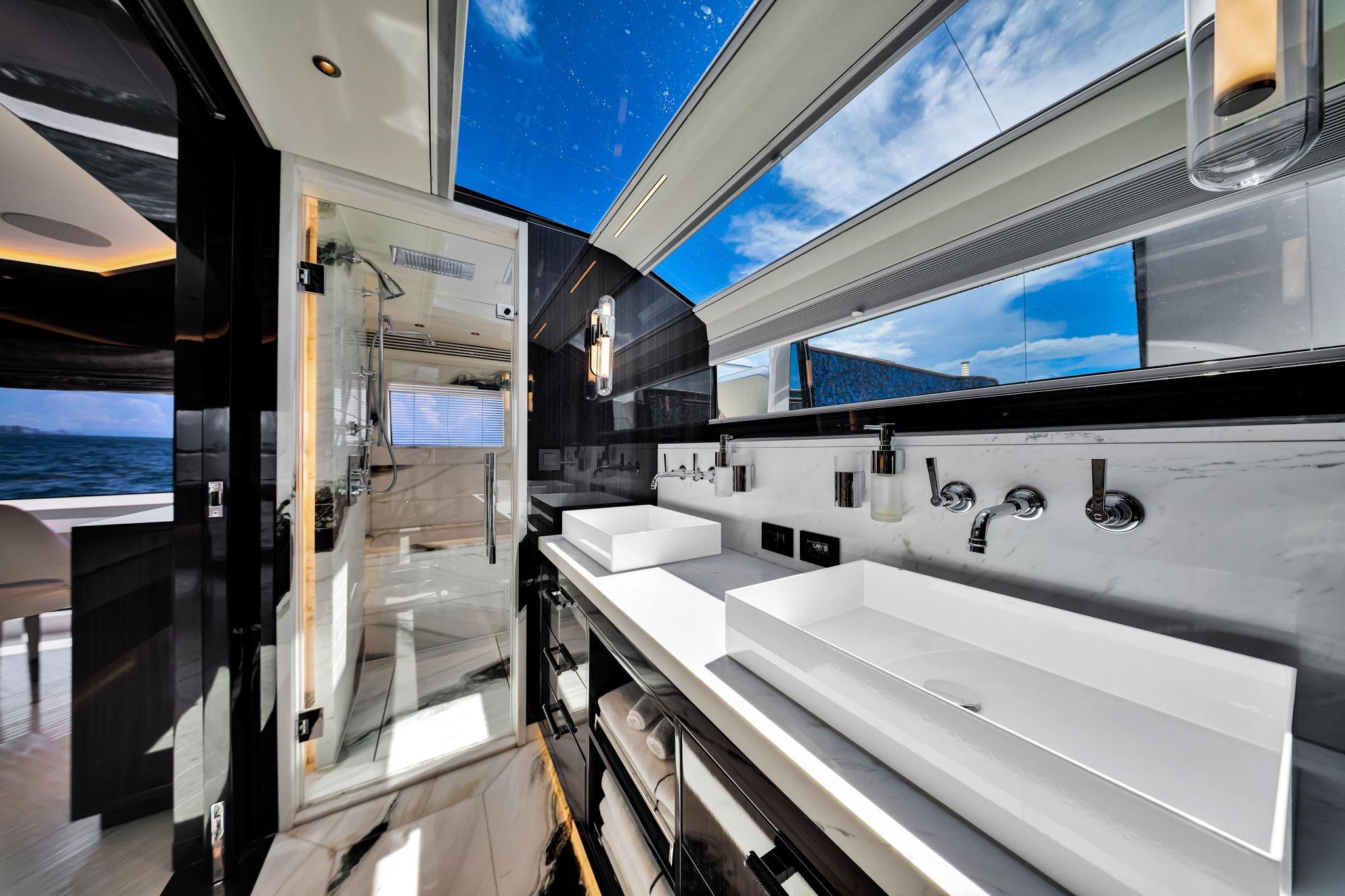 Luxurious bathroom interior on 2021 Sirena 88 yacht with ocean view and modern fixtures.