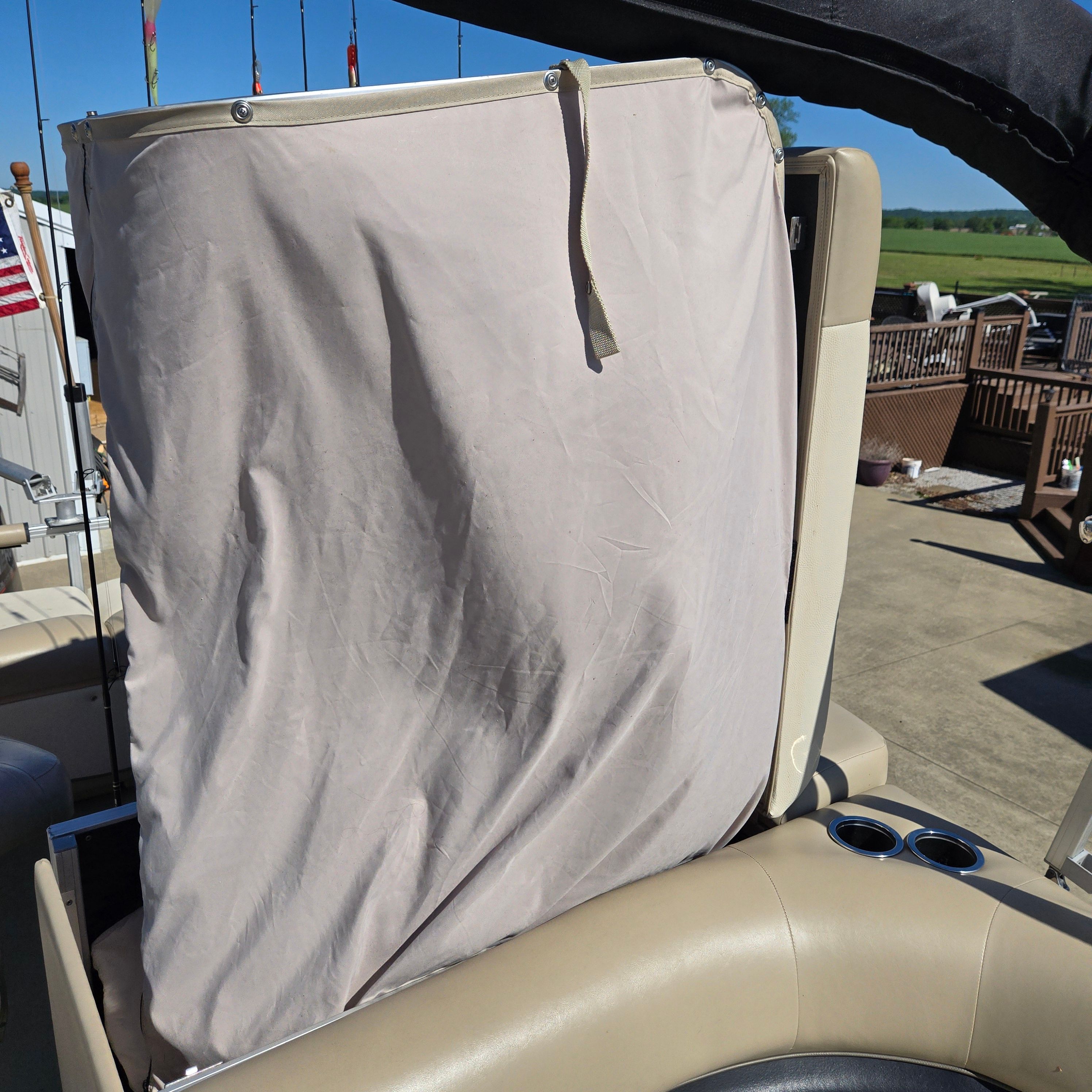Cover on a boat seat with cup holders.