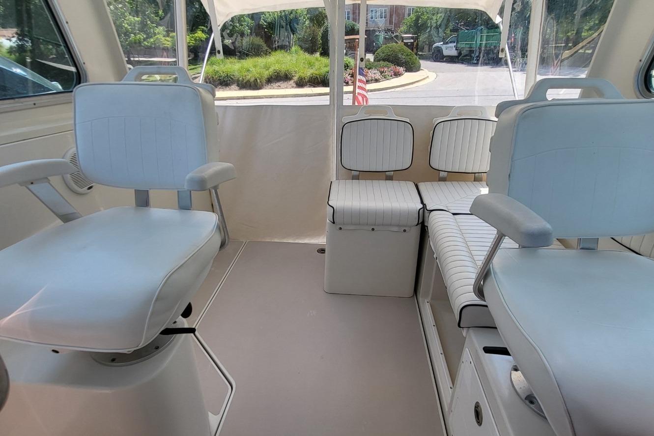 Interior of a 2006 Back Cove 29 boat with white seating and spacious layout.
