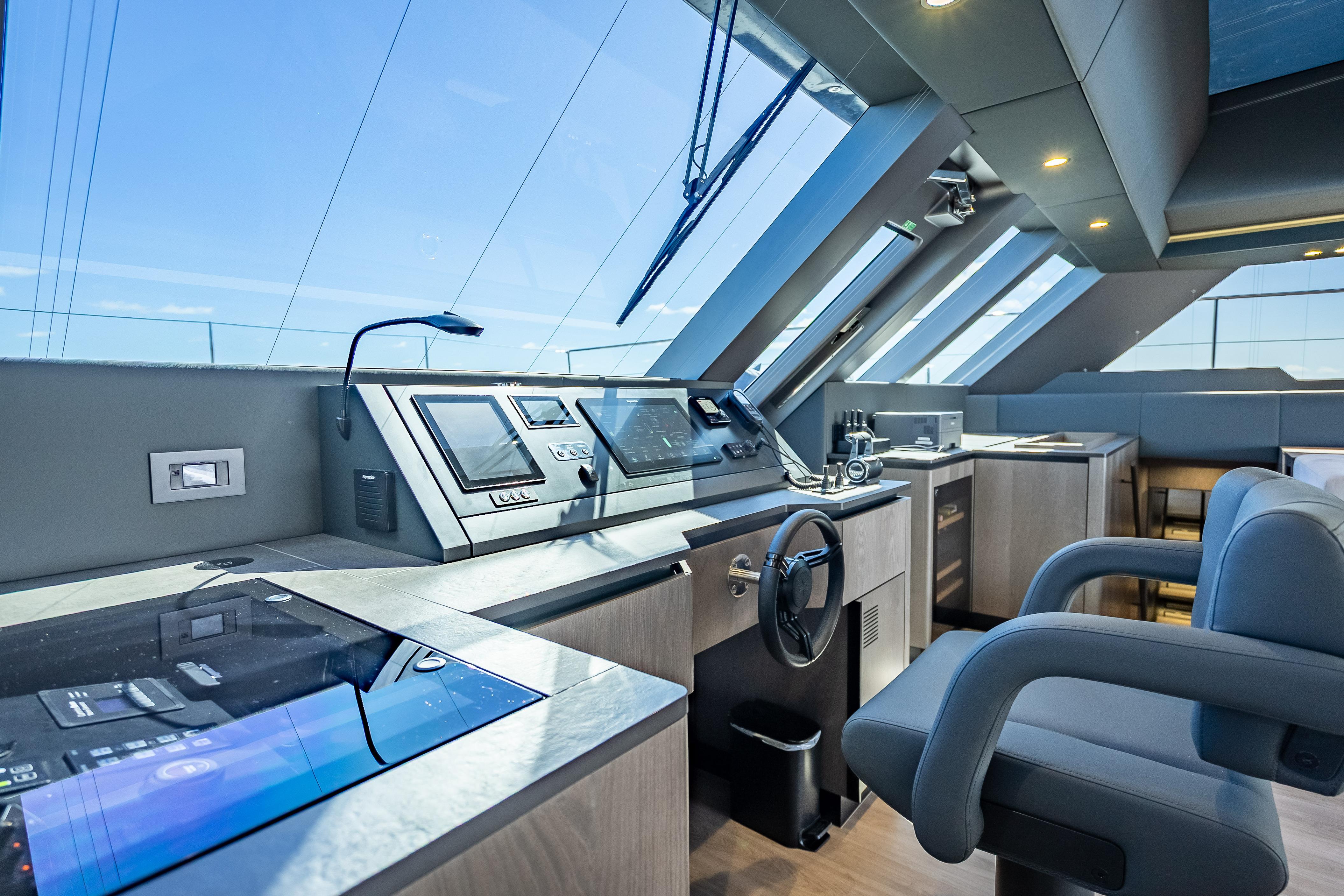 Luxurious helm of 2026 Sunreef 60 Power yacht with modern navigation equipment.