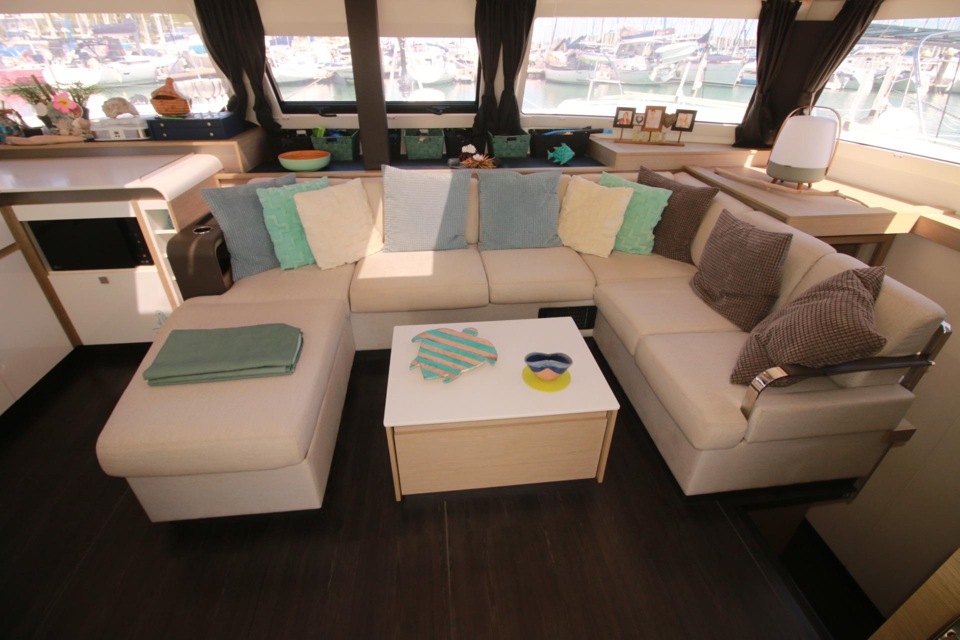 Luxurious interior of 2022 Fountaine Pajot Elba 45 Catamaran with cozy seating and decor.