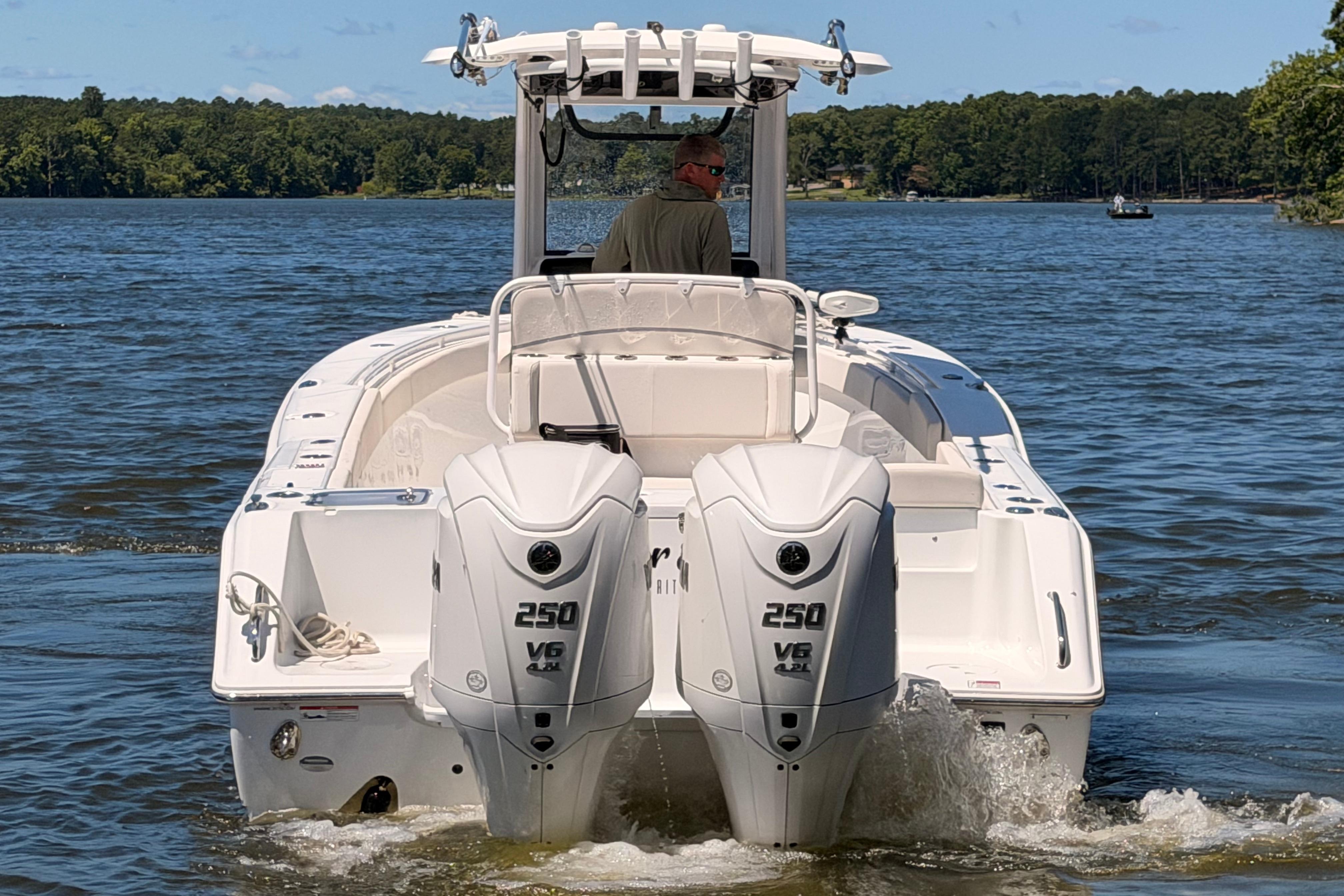 2024 Sea Hunt Gamefish 27 Coffin Box boat with dual 250 V6 engines on a lake.