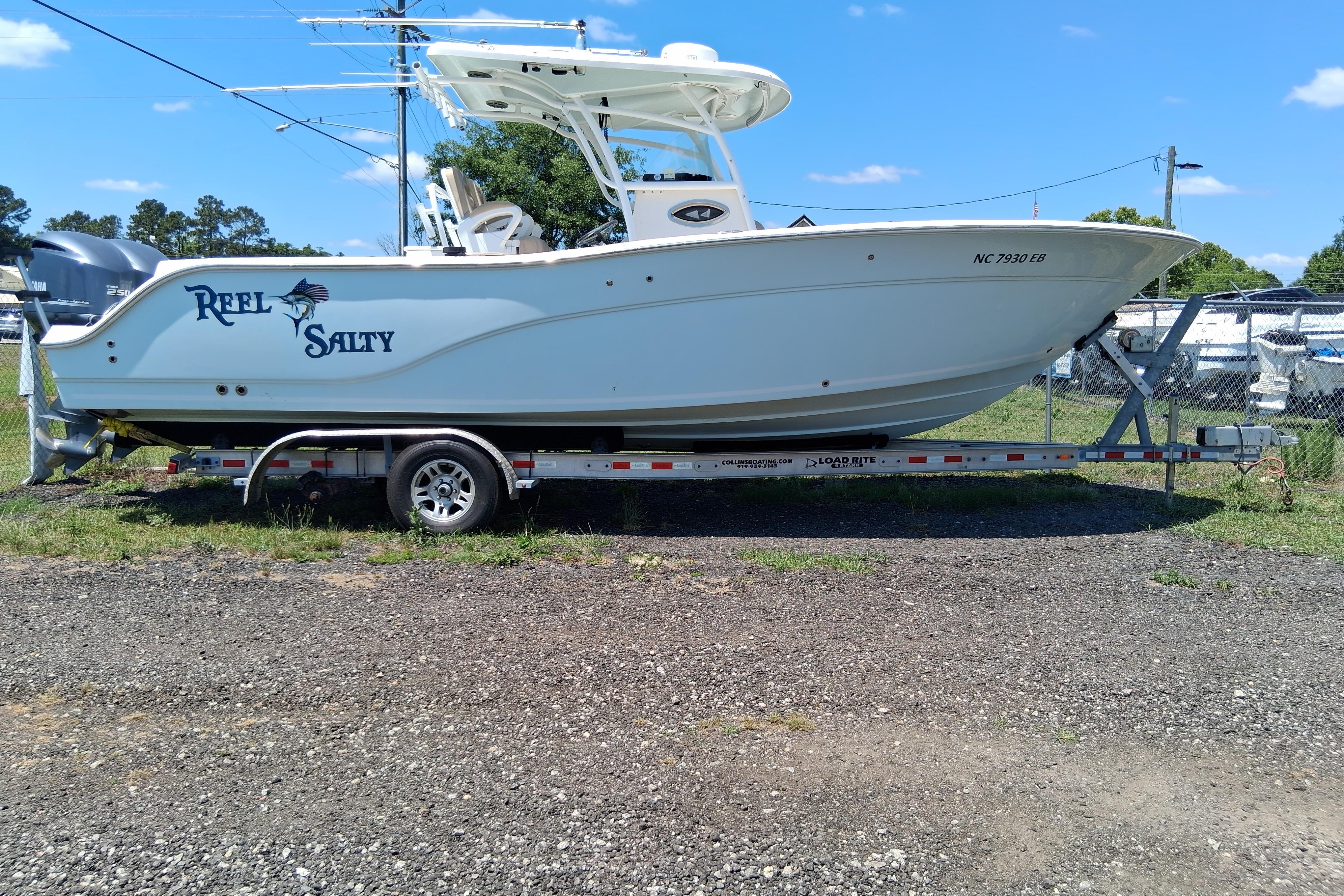 2015 Sea Fox 286 Commander boat on trailer, labeled "Reel Salty," parked outdoors.
