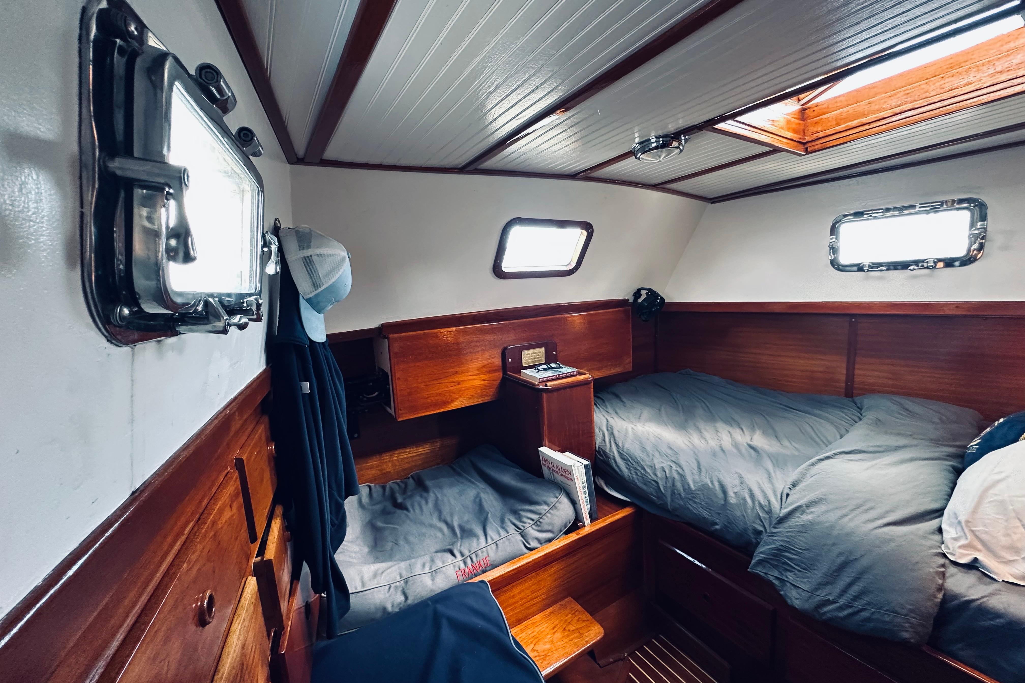 Interior of 1971 Alden Boothbay Explorer yacht with cozy wooden cabin and twin beds.