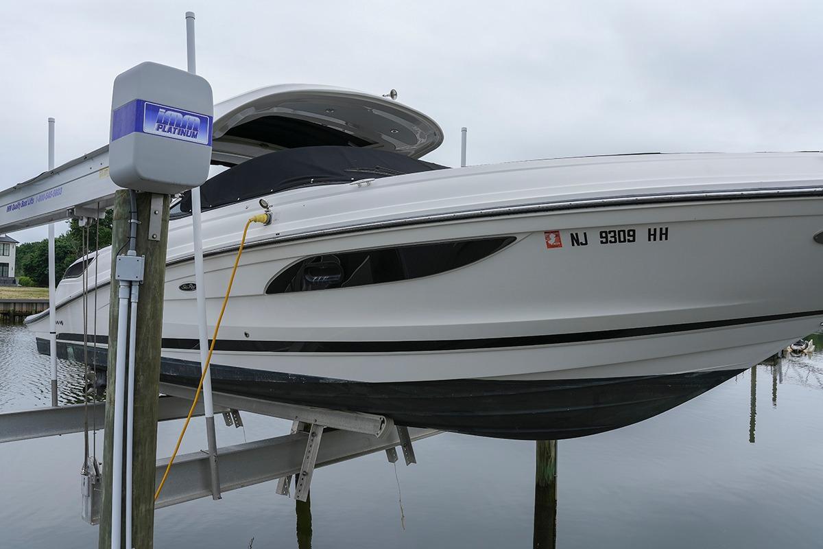2018 Sea Ray SLX 350 boat on lift, docked at marina.