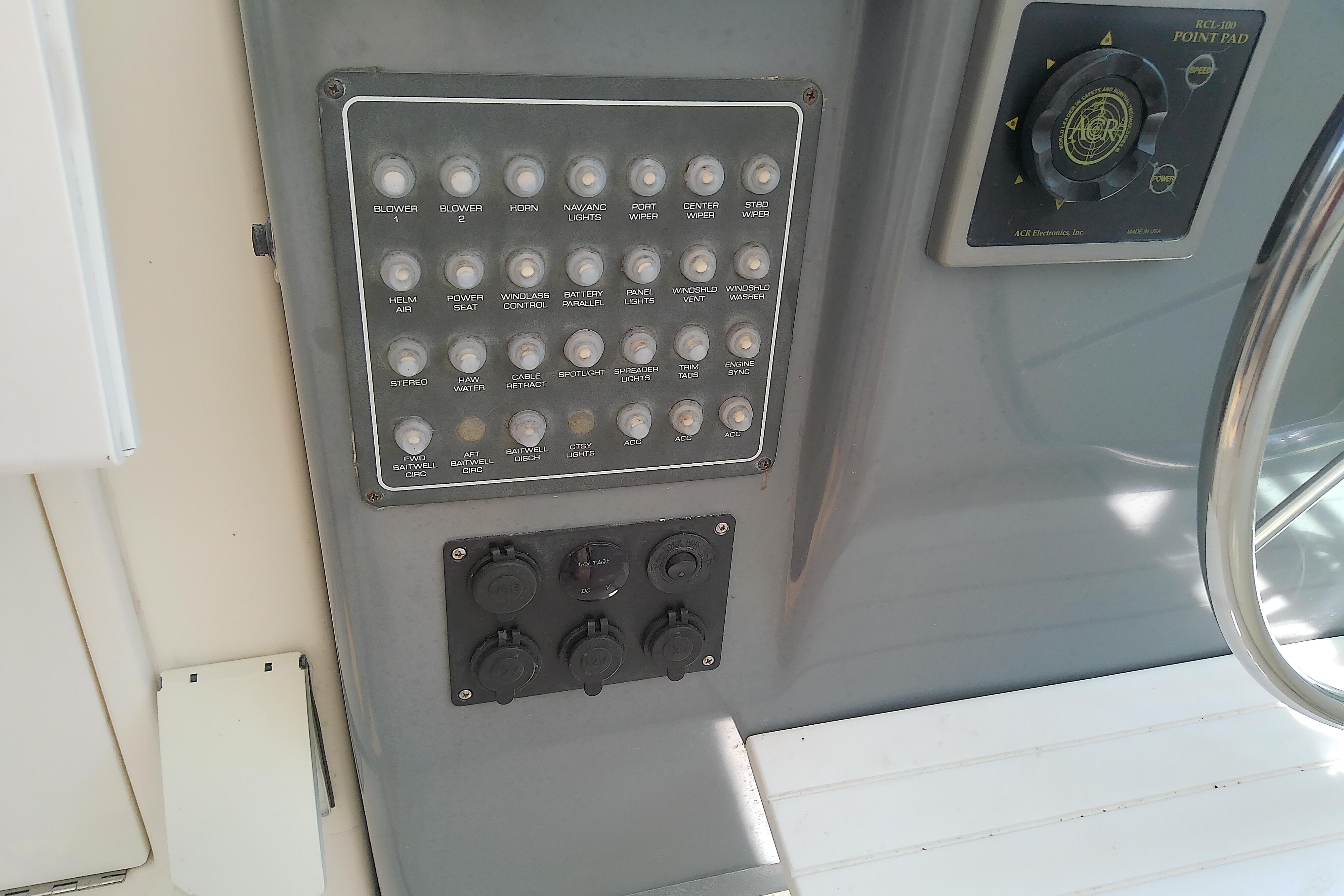 Control panel of a 2000 Tiara Yachts 4100 Open, featuring various switches and dials.
