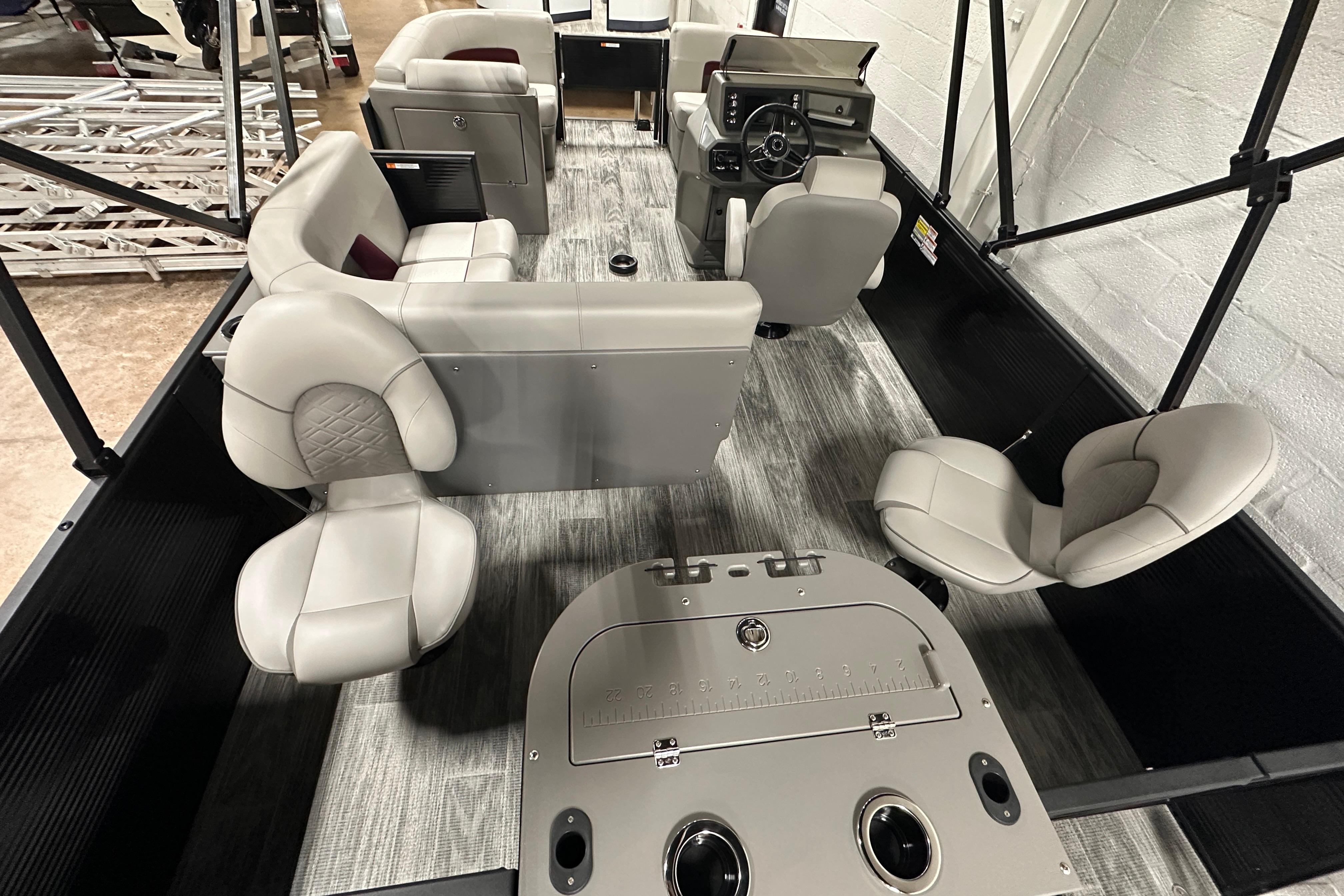 2025 Qwest 18 XRE Cruise boat interior with modern seating and steering console.