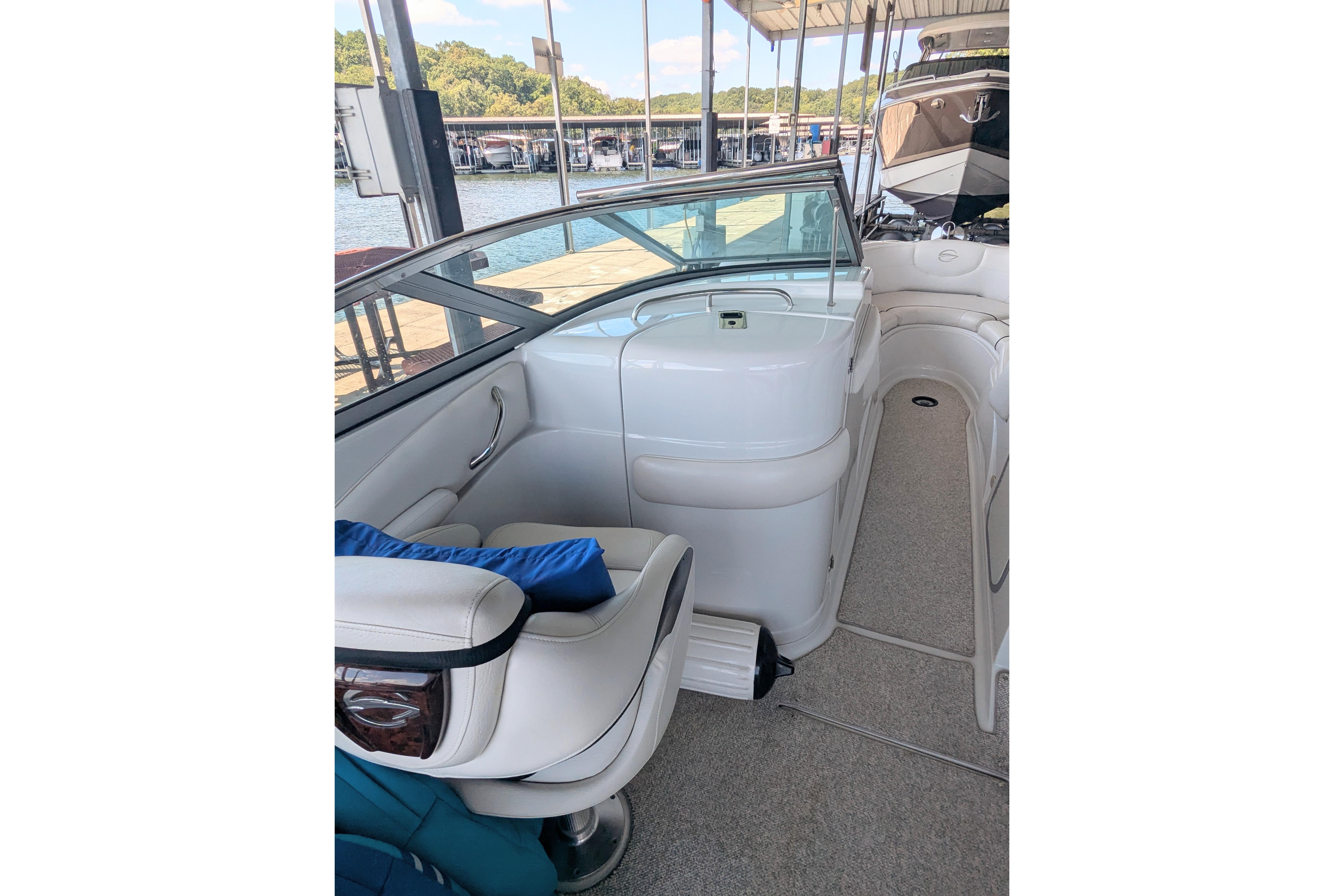 2008 Crownline 300 LS boat interior with white seating and dock view.