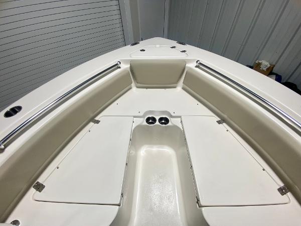 2024 Key West 219 FS boat bow seating area with storage compartments.