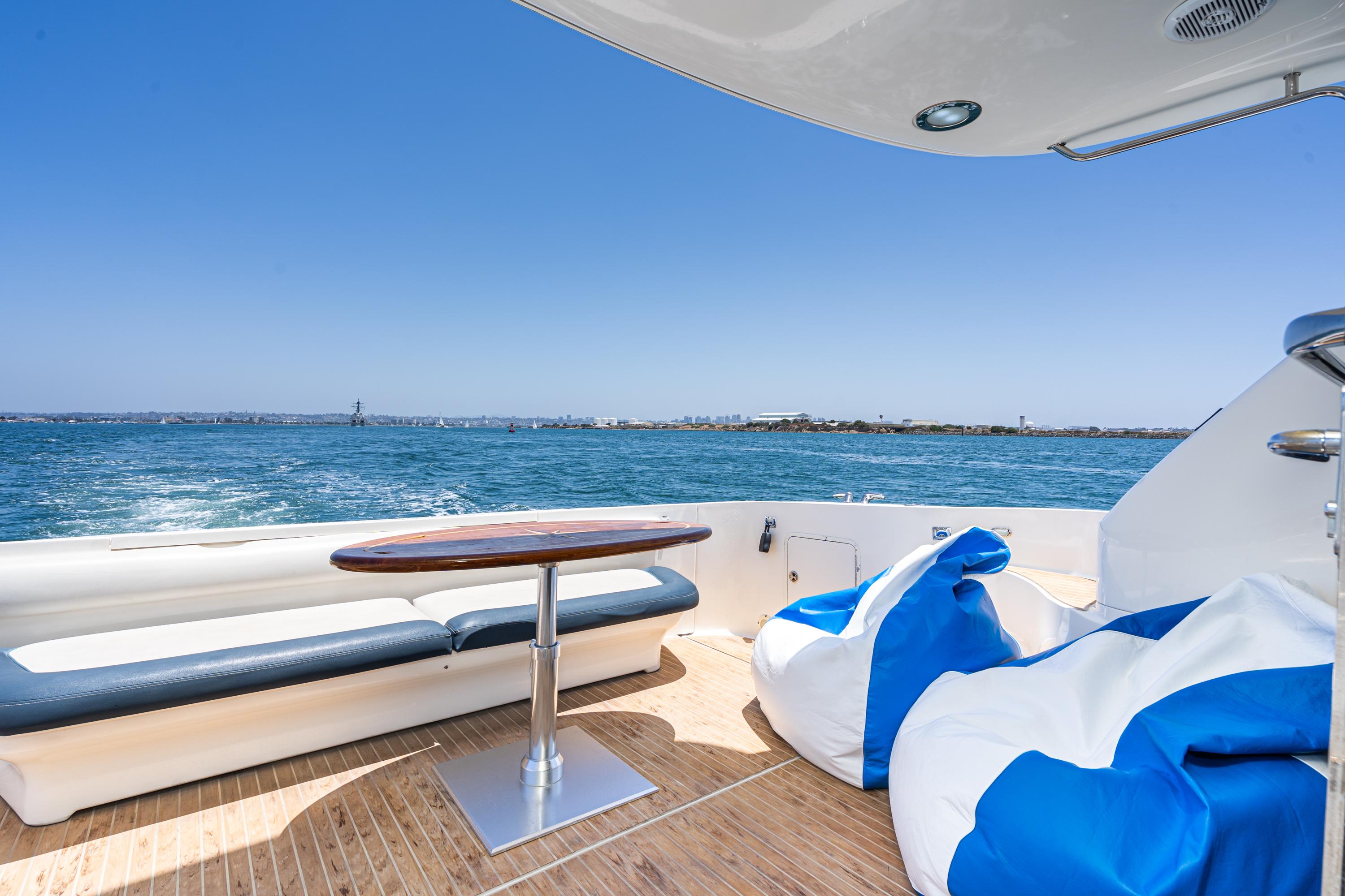 Luxurious 2001 Sea Ray 560 Sedan Bridge yacht deck with ocean view and seating.